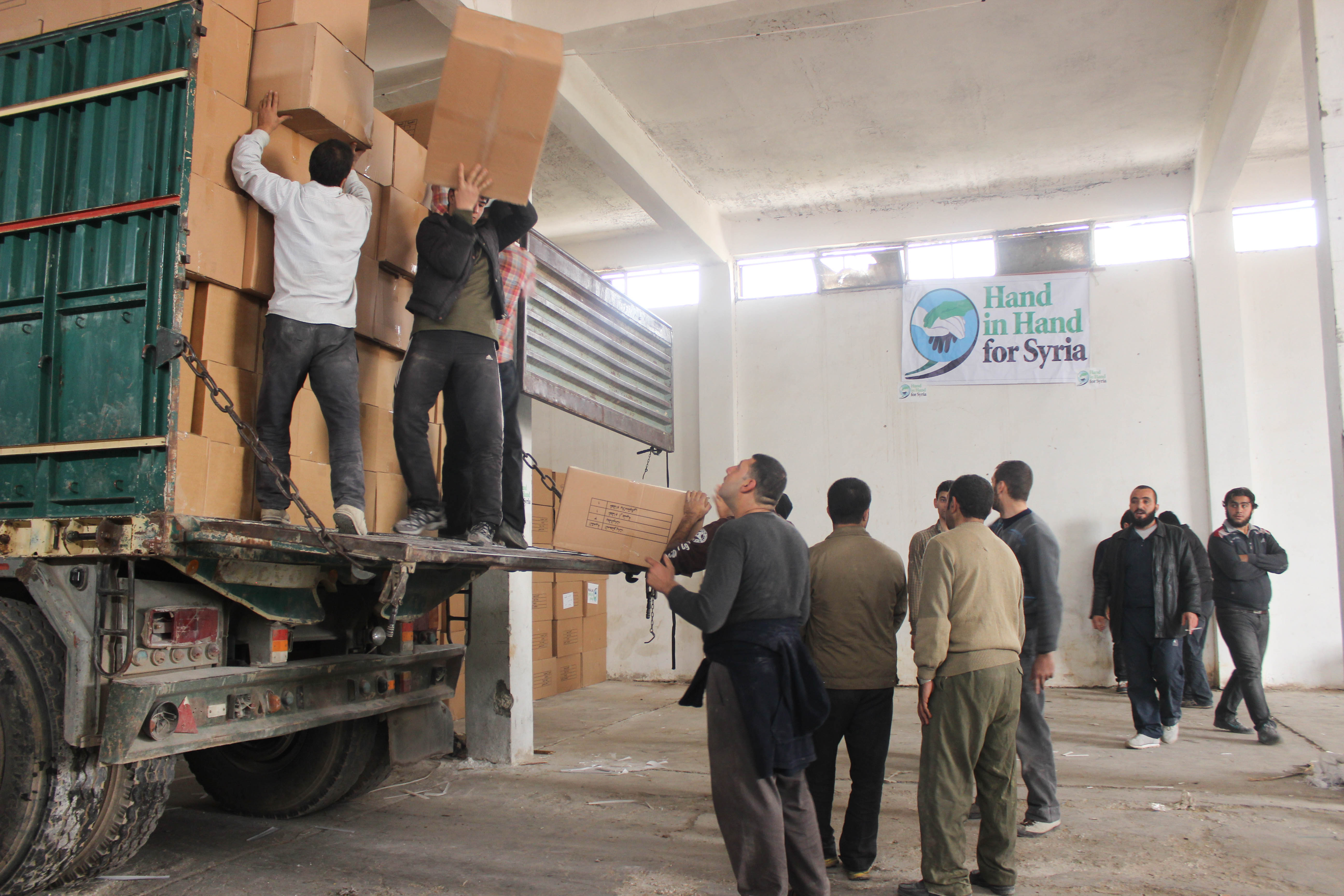 UK-registered charity Hand in Hand for Syria loading up an aid distribution van from its warehouse in Northern Syria. Few international aid agencies can work inside Syria due to security concerns. March 2015