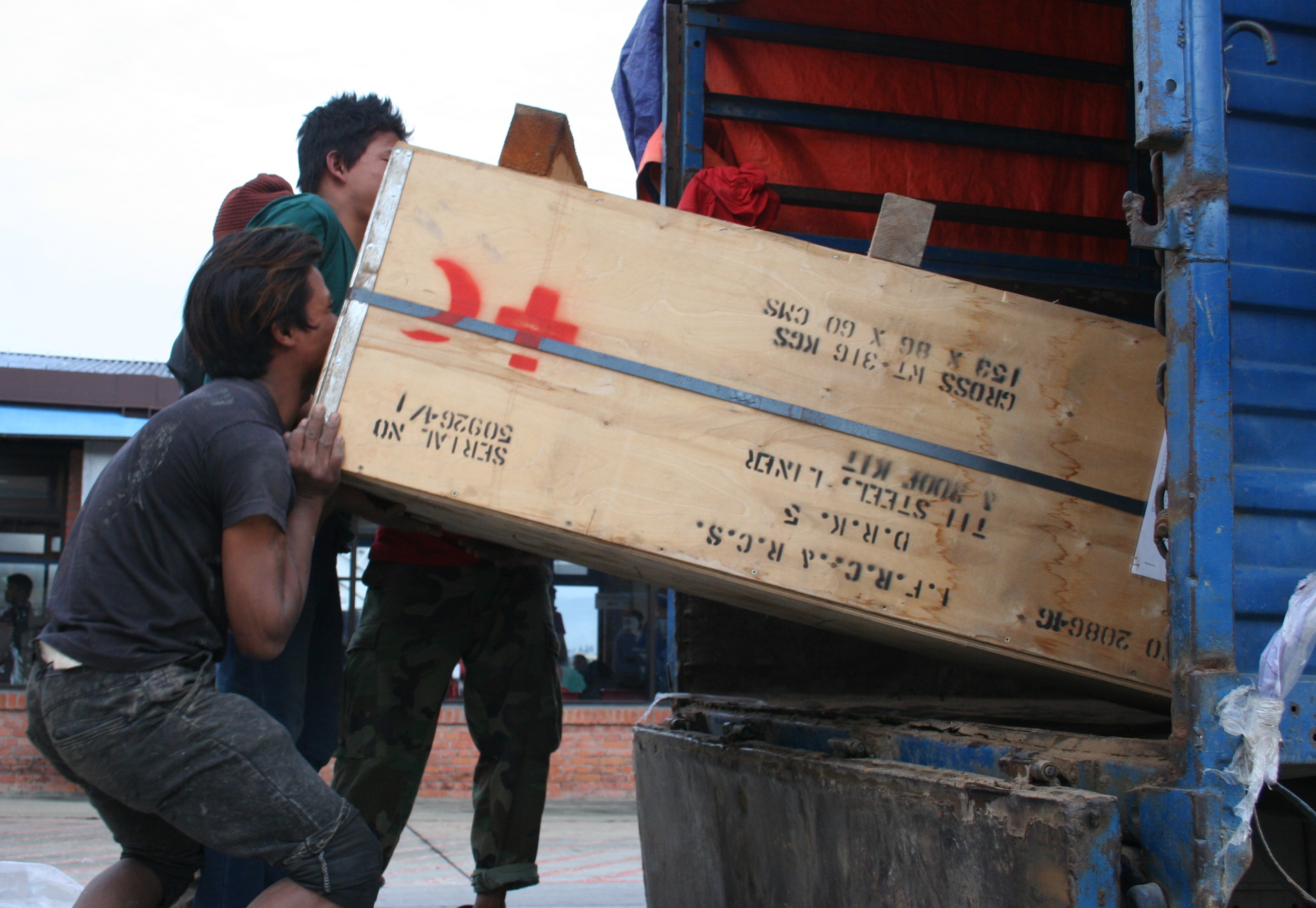 Workers load Red Cross relief supplies arriving at Tribhuvan International Airport in Kathmandu as part of the response to the 7.8-magnitude earthquake that hit on 25 April 2015. 