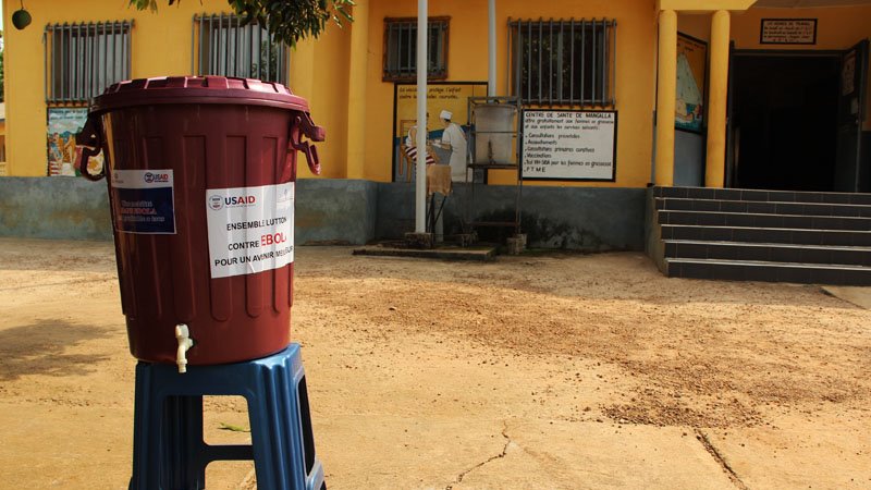 Disinfecting handwashing stations sit outside many buildings and homes throughout Guinea