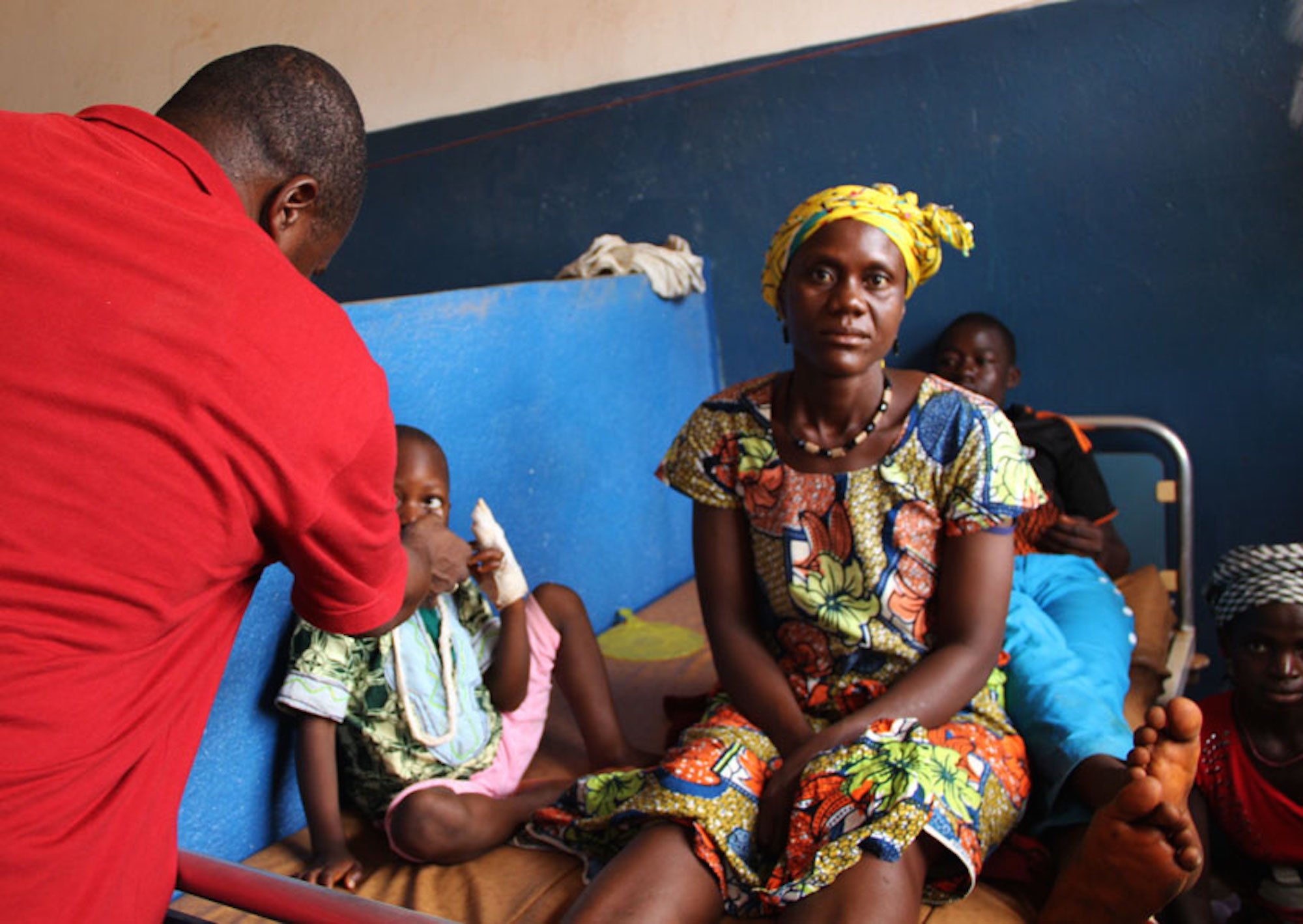 Doctor Kalissa N’Fansoumane (in red) sees patients at a hospital in Gueckedou in April 2015