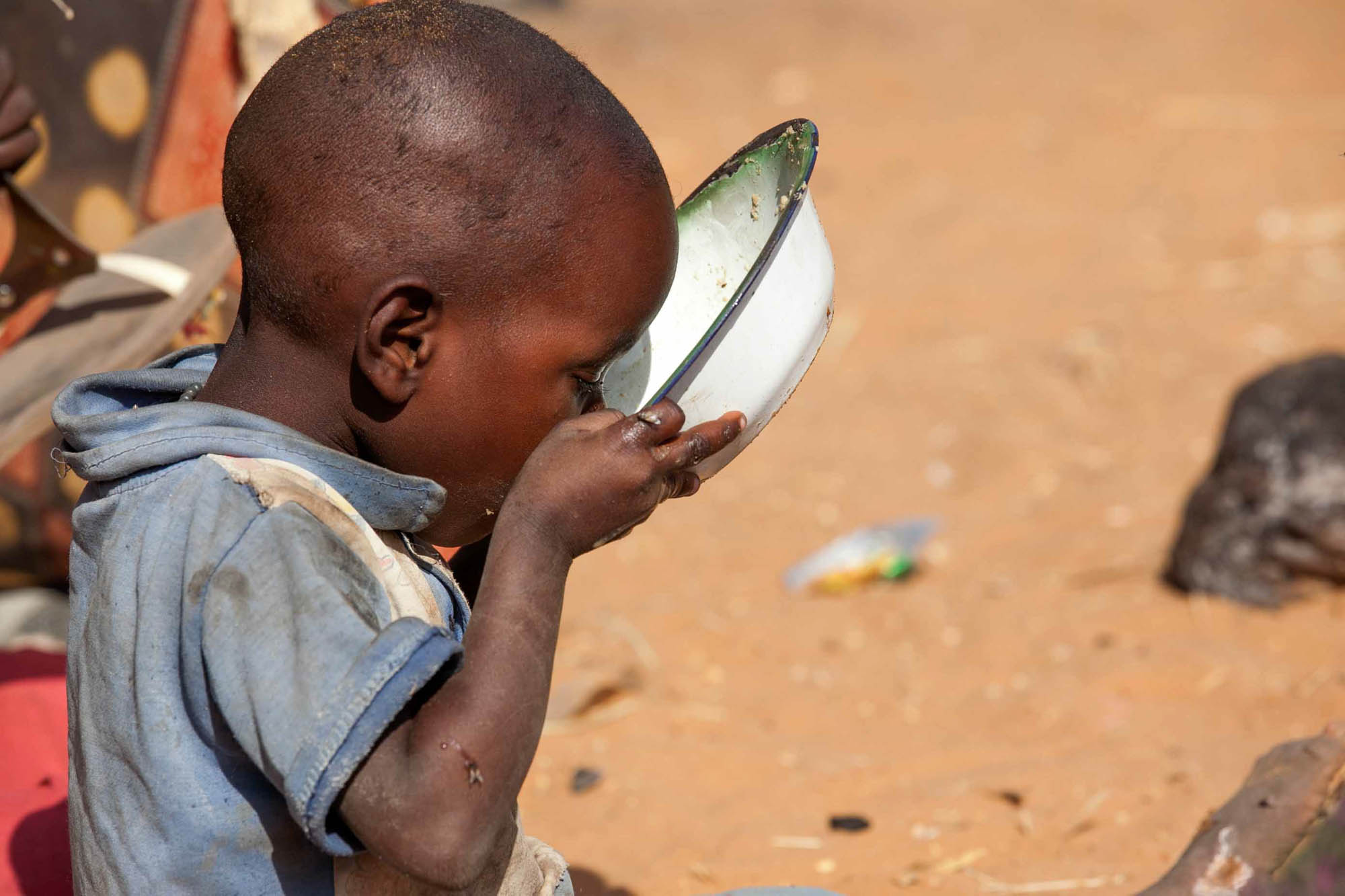 18 February 2015. Zam Zam: A newly displaced child drinks water in Zam Zam camp for internally displaced people (IDP) in North Darfur. His family arrived to this camp as they flee fighting between Government and armed movements in the area of east Jebel M