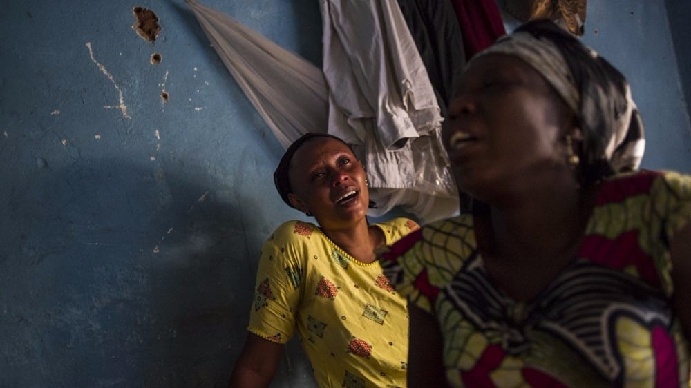 Relatives of a student killed last night in the Jabe neighbourhood of Bujumbura mourn at home in the Burundian capital on June 28, 2015. At least two people were killed last night during violence