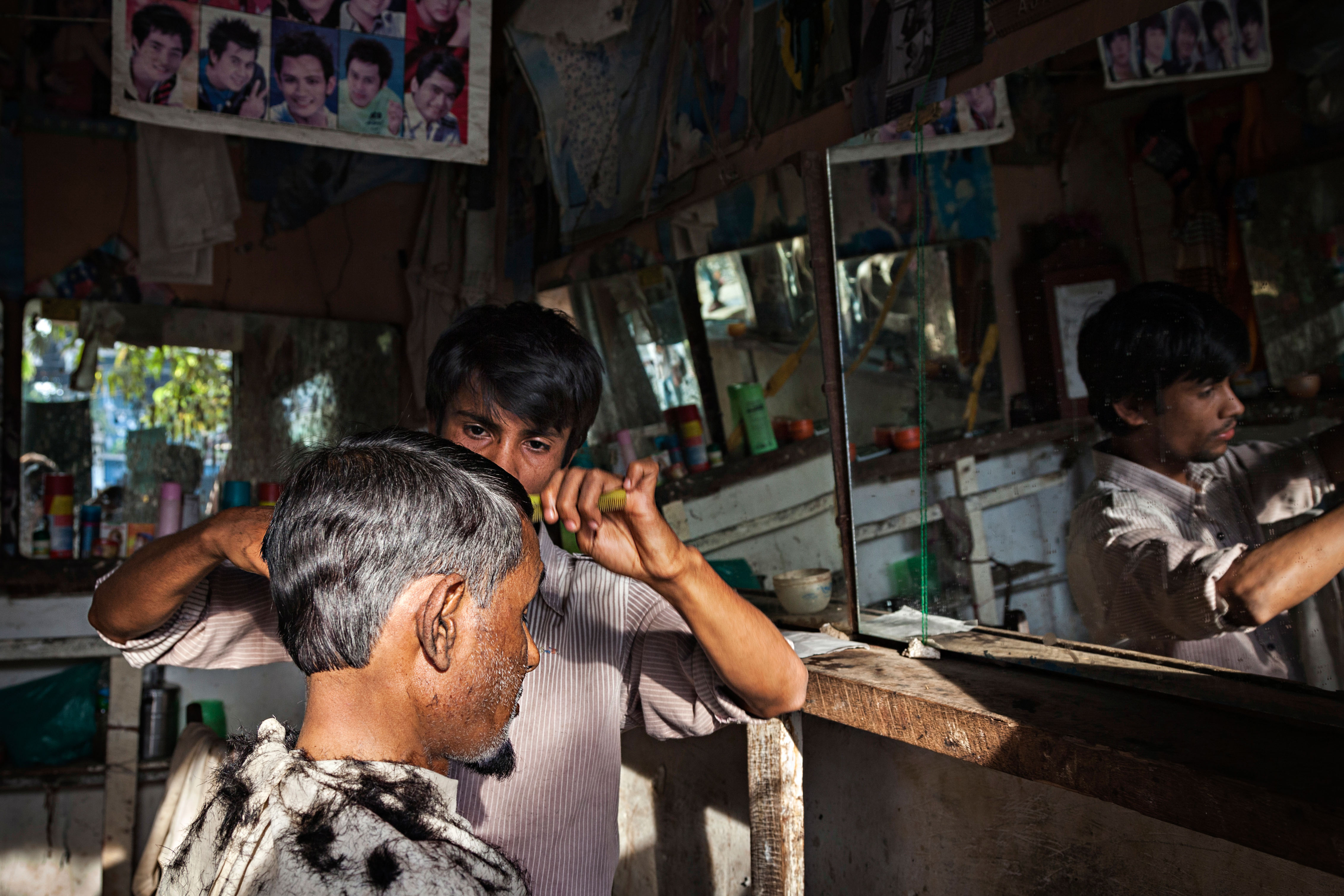 A Rohingya man gets his hair cut in the main market in Buthidaung, a township in Myanmar's western Rakhine State in early 2014.