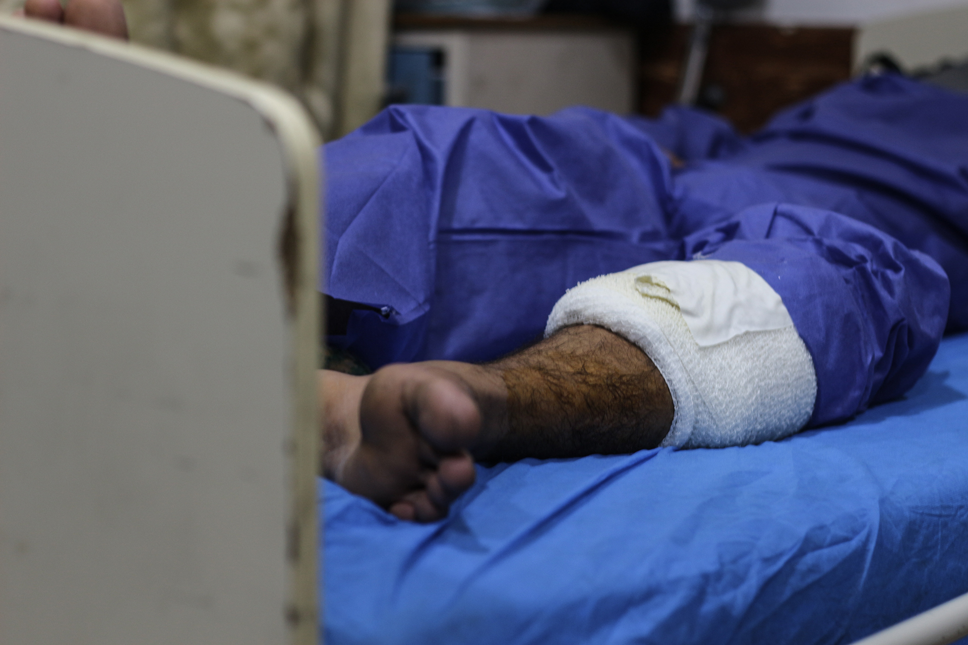 A man who was shot in the leg during the demonstrations rests at Baghdad's Martyr Sadr hospital, where many protesters were treated.