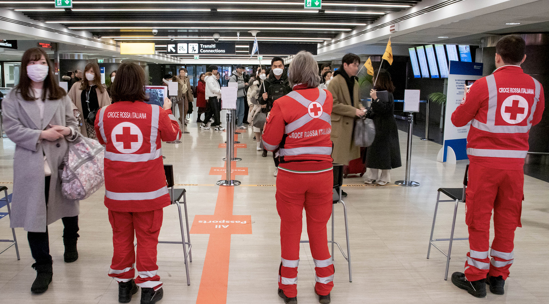 Volunteers scanning passengers’ temperatures