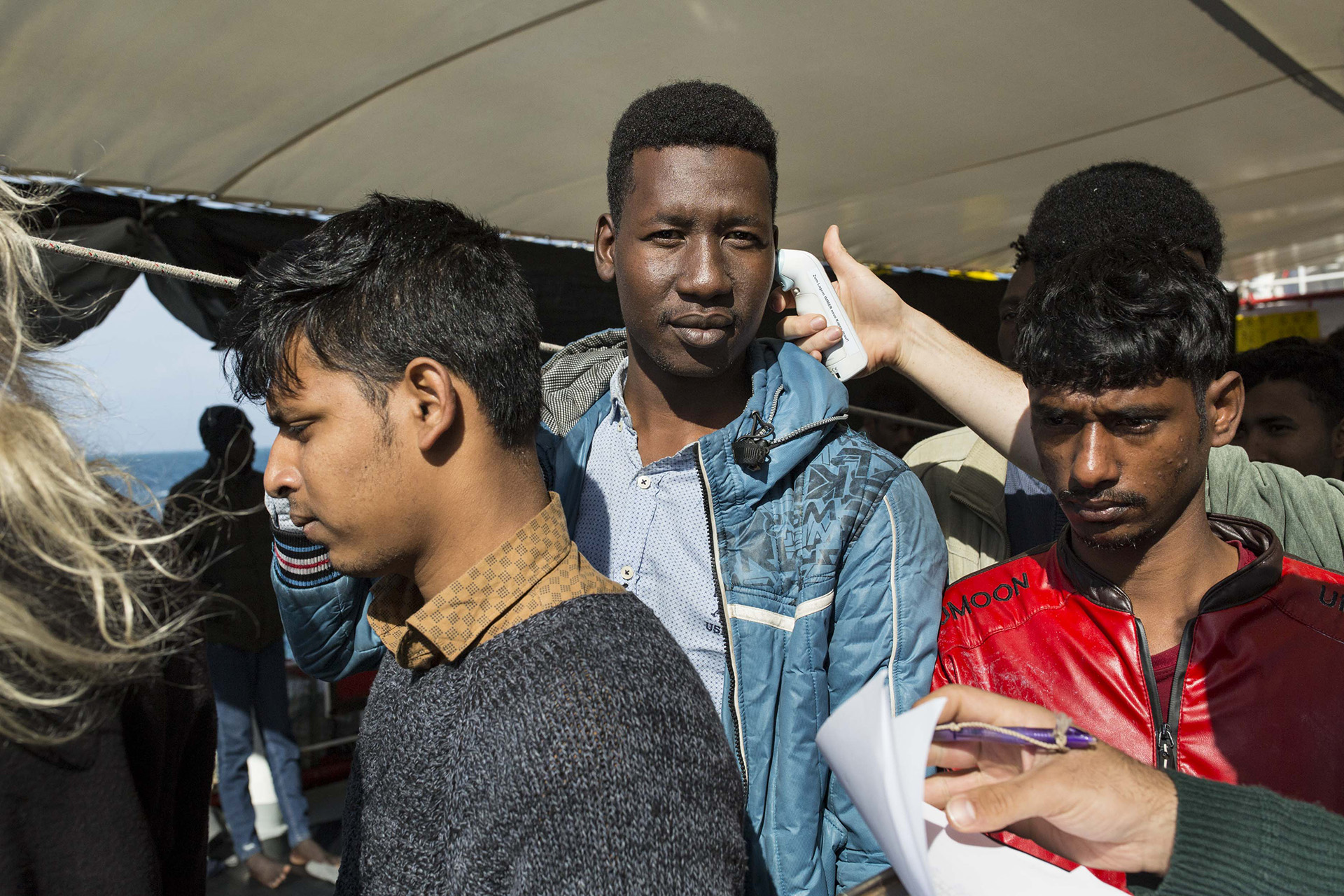 Image of Sea-Watch 3's on-board doctors checking body temperatures