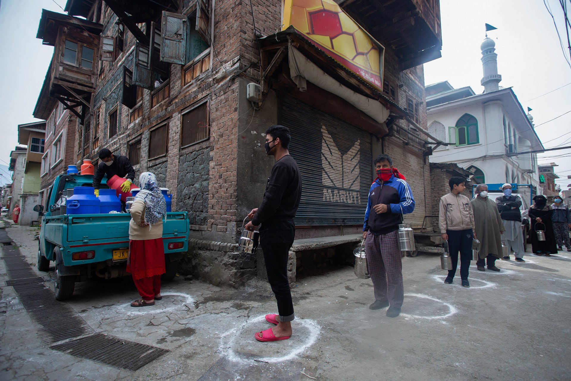 People queue for milk during April lockdowns in Srinagar