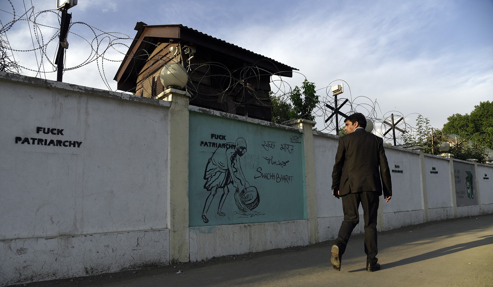 A man stares at graffiti