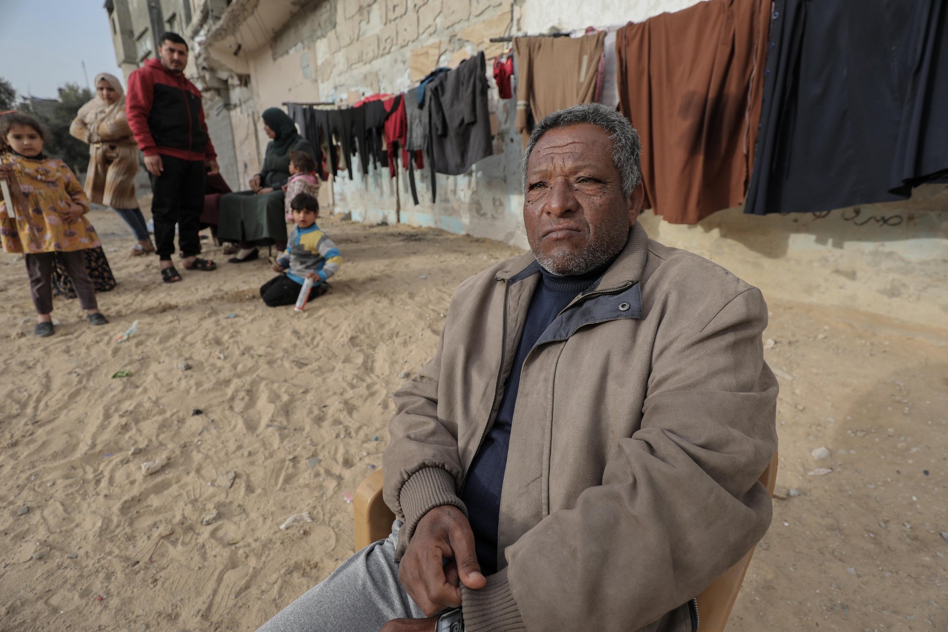 Khaled Nasser in front of his Gaza home, after he boarded up the outside. It remains uninhabitable.