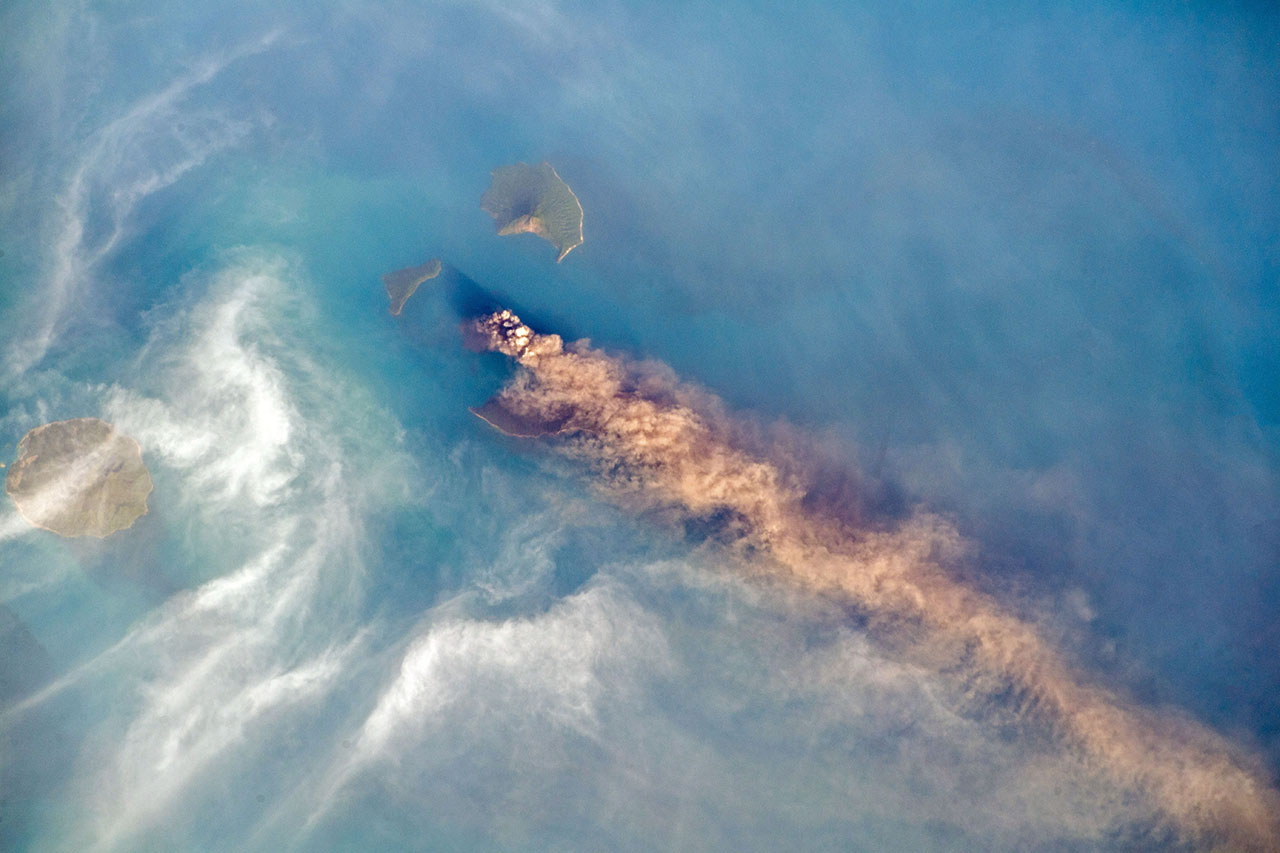 Krakatau seen from above as plumes billow in the wind