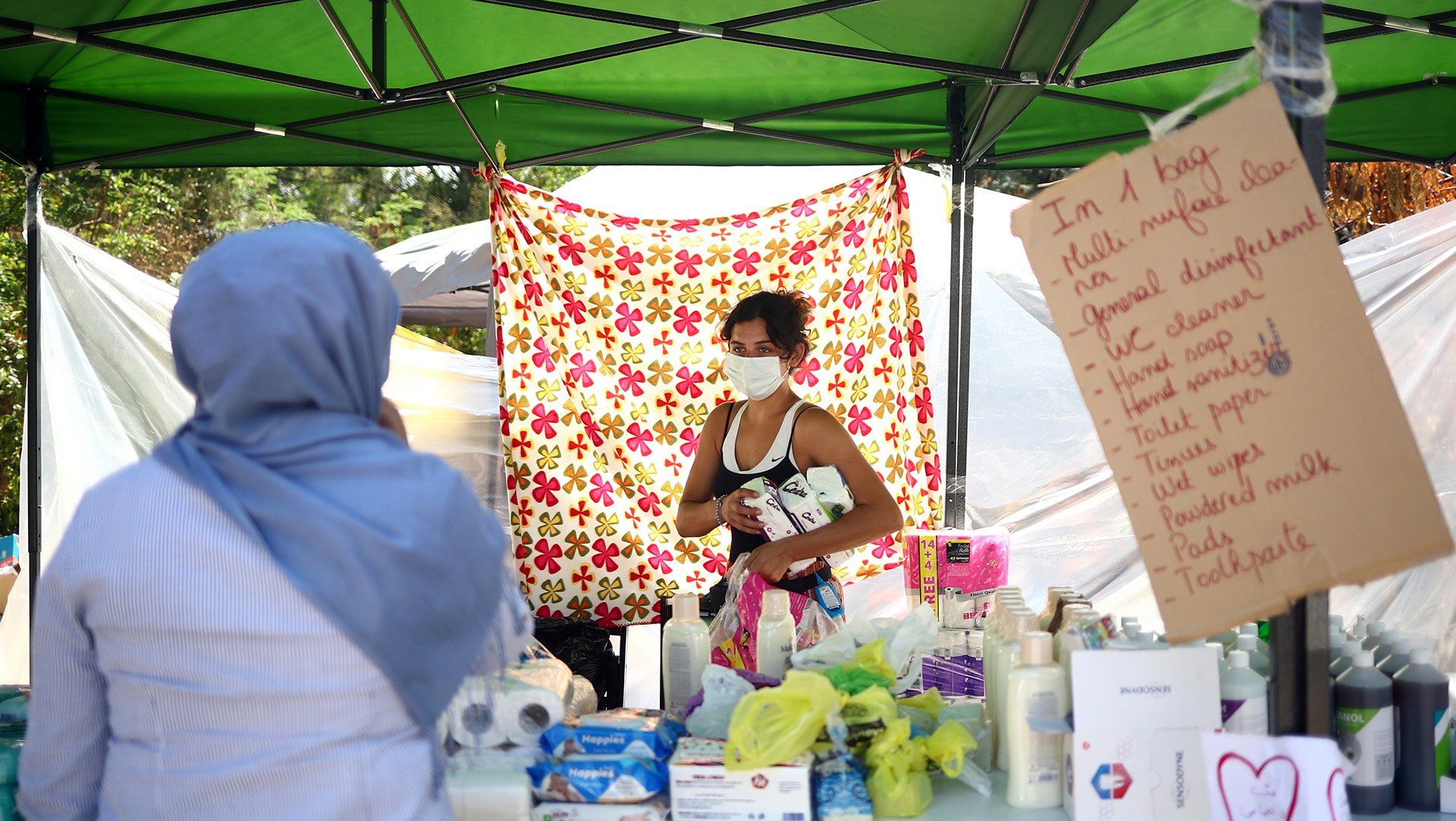 A Lebanese volunteer sorts through donations at a stall offering emergency relief in the aftermath of the Beirut port explosion in August 2020. But who exactly is “local” when it comes to aid's localisation agenda?