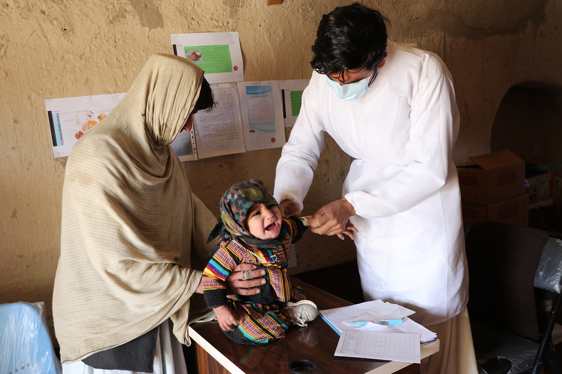 A baby girl is screened for malnutrition in a remote health facility in the southern district of Spin Boldak, close to the border with Pakistan.