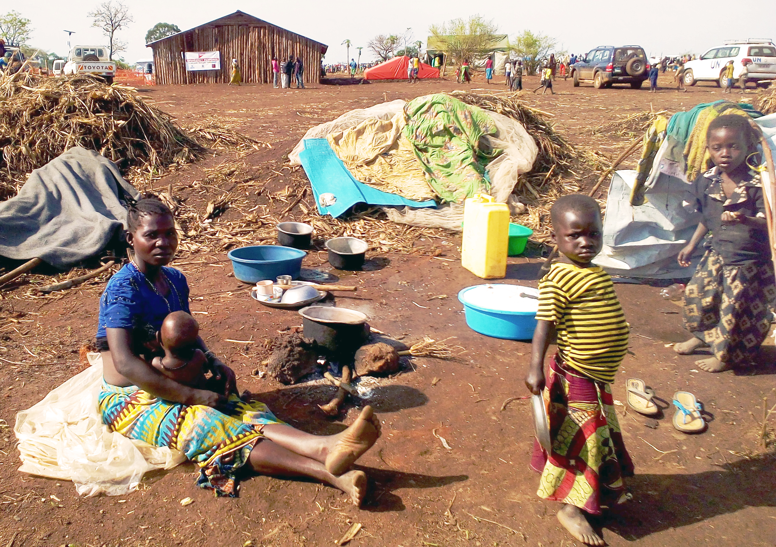 A young female refugee from Ituri Province carrying their baby at the back at Maratatu camp,  Kyangwali refugee settlement in Hoima district