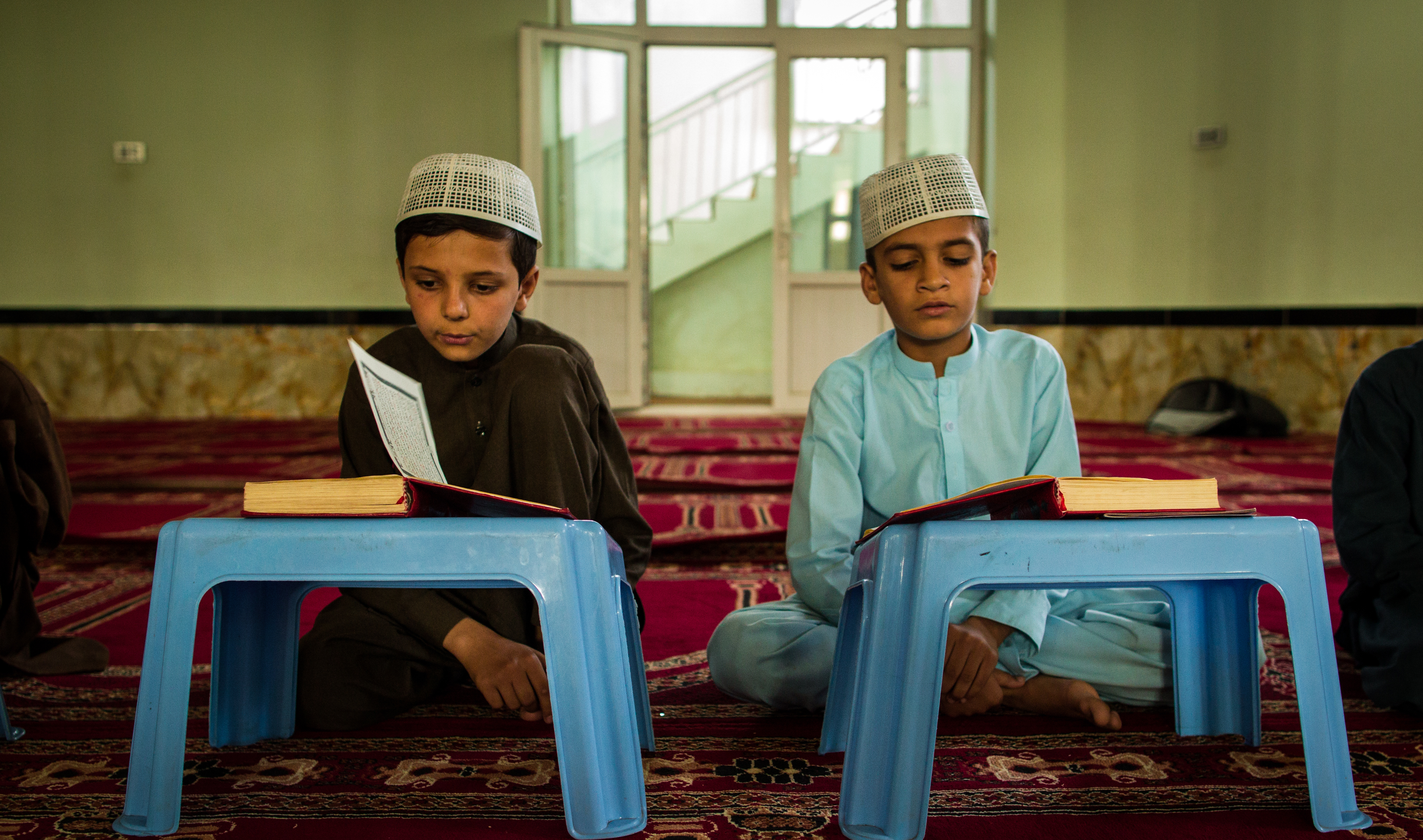 Two children reading at a mosque in Kabul