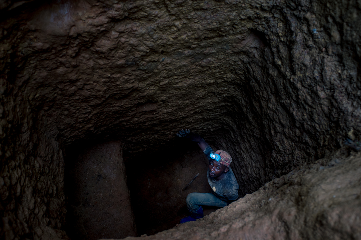 A miner enters a coltan mine in Kisengo, DRC