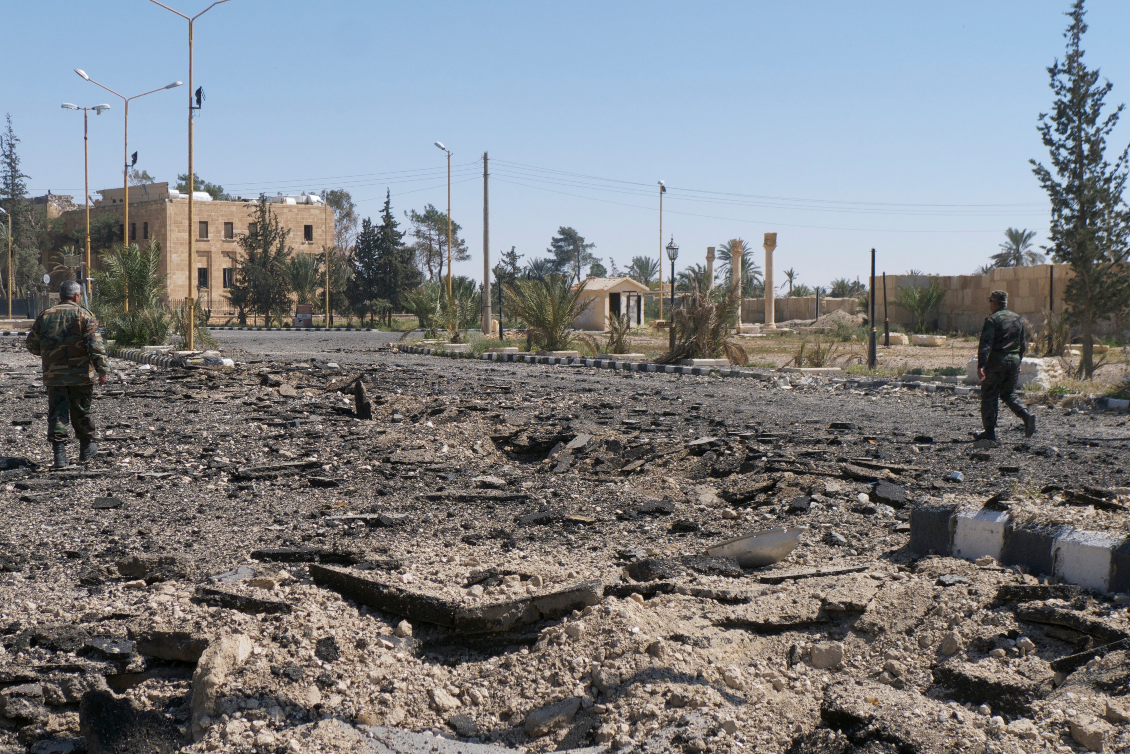 Syrian soldiers on torn up roads