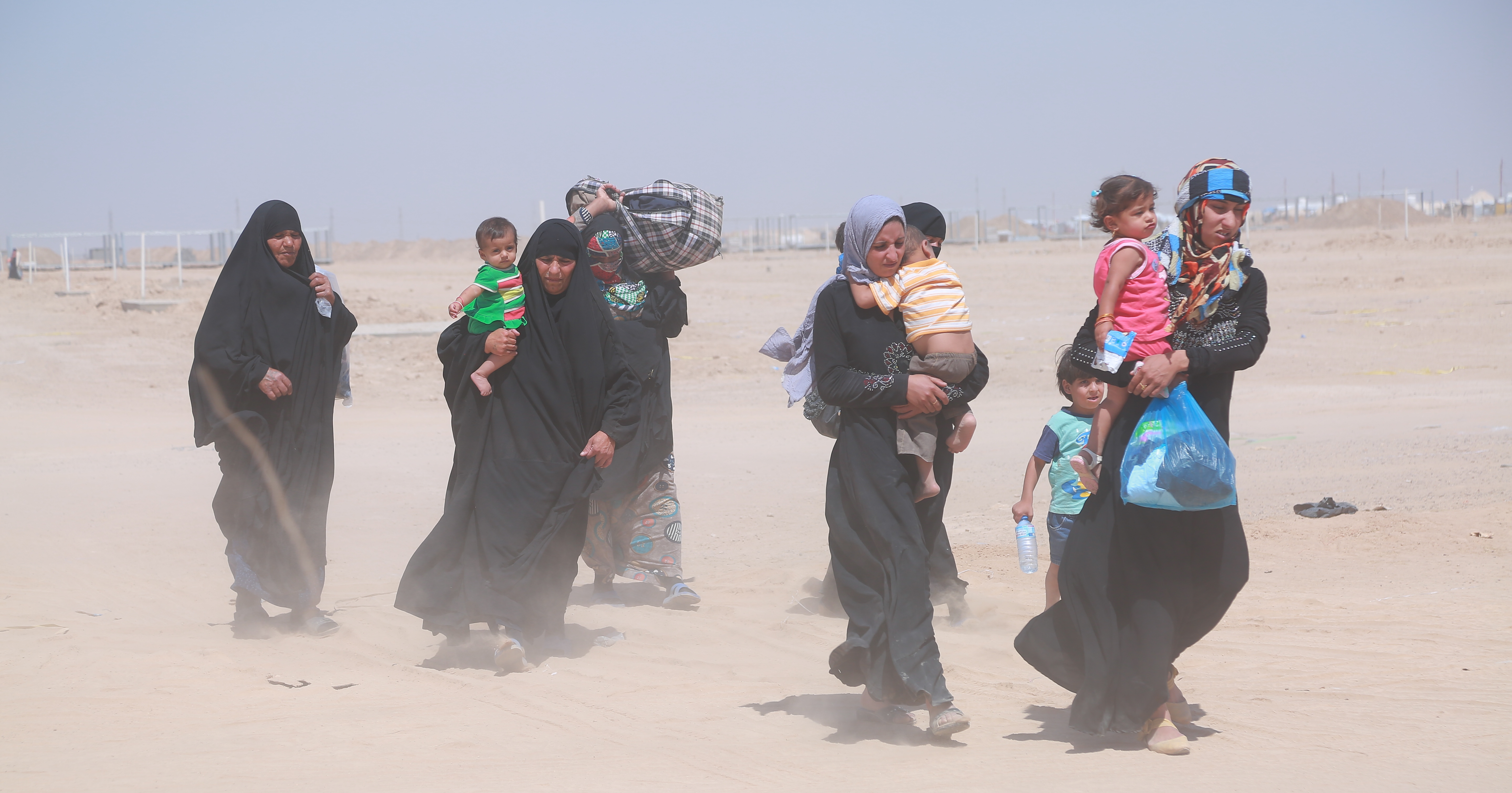 Women walk in the desert