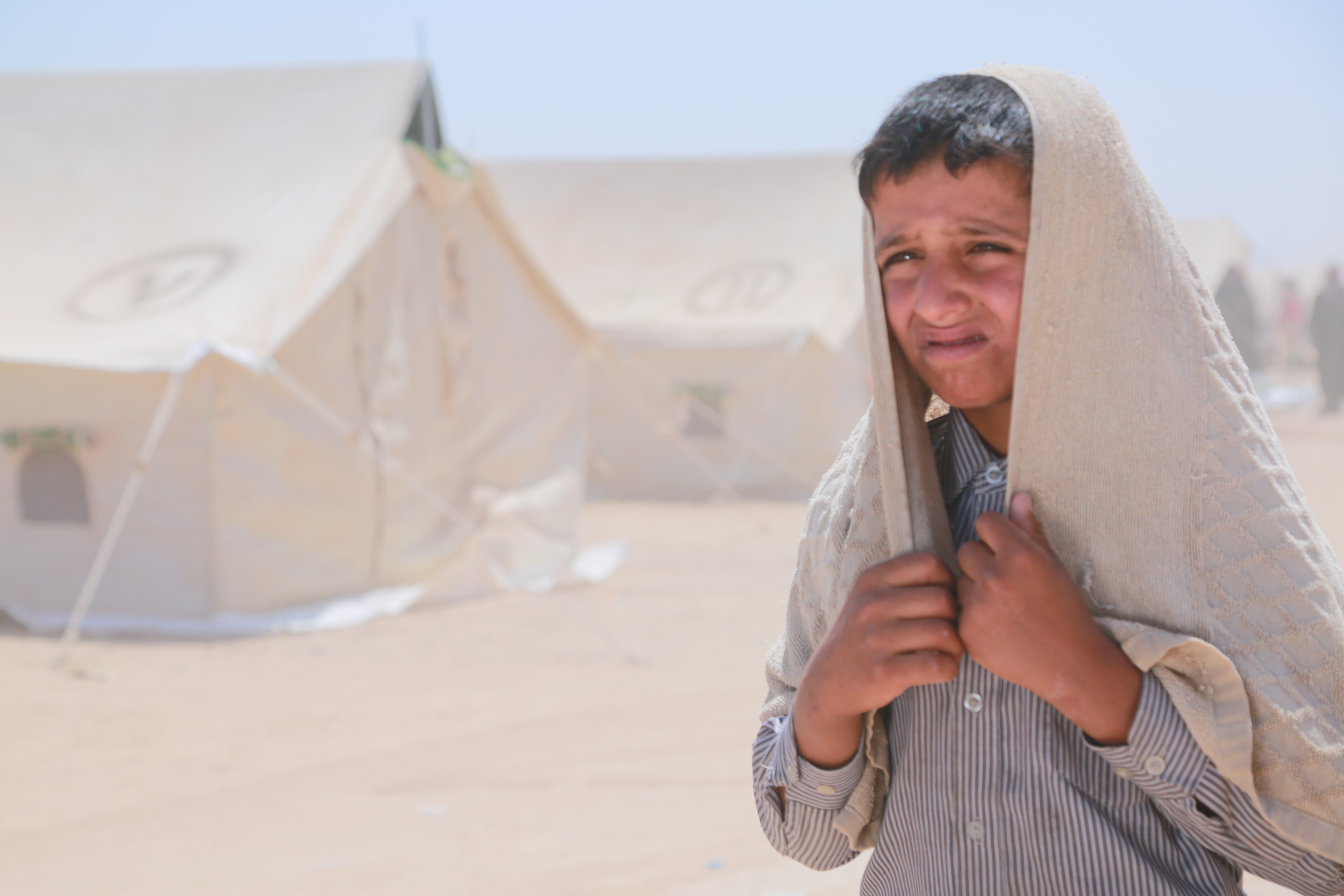 Boy in desert camp