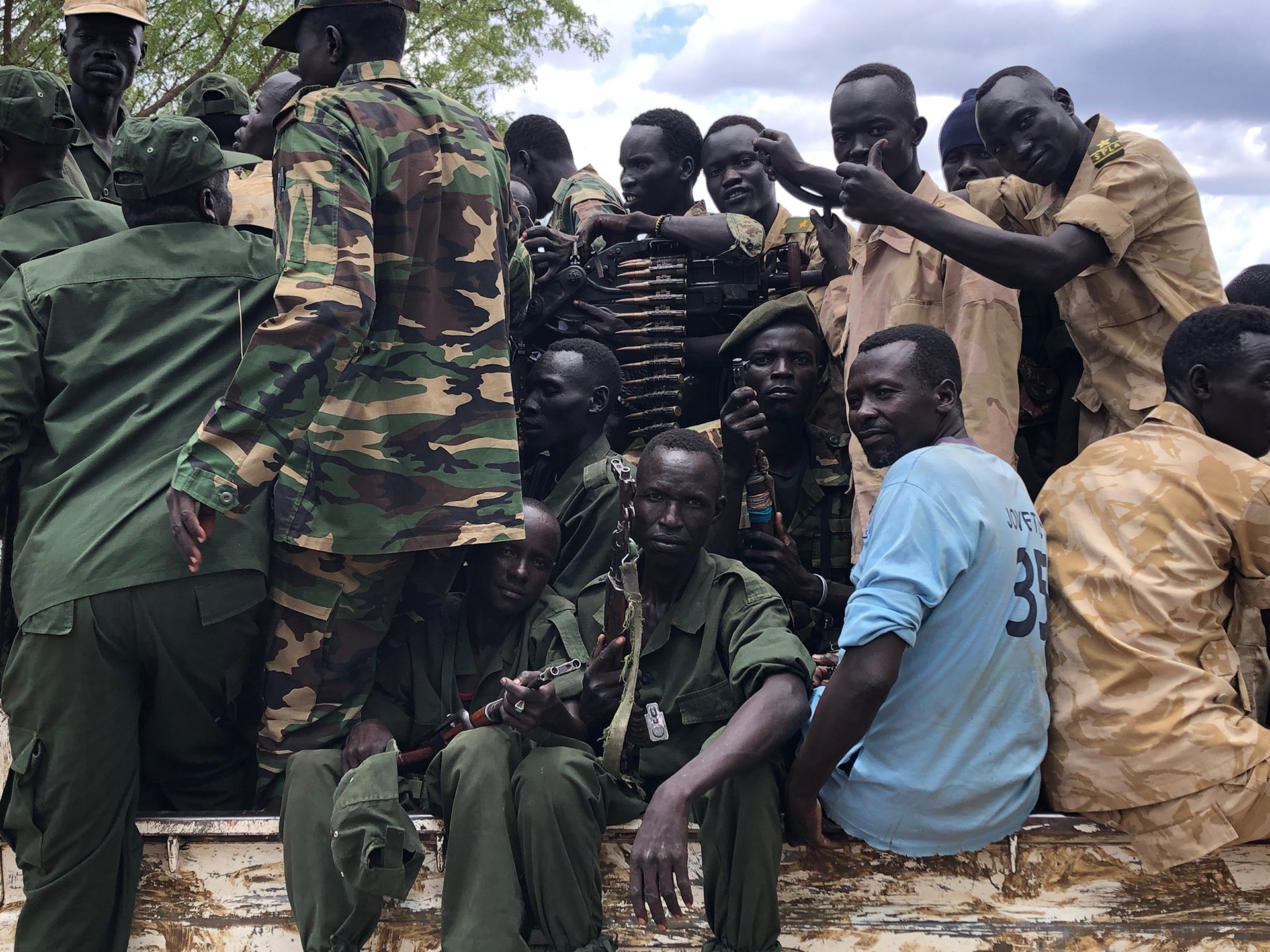 Soldiers hop into the back of a truck on their way to celebrate the arrival of rebel leader Malik Agar who came to Ulu for the first time since fighting erupted within the movement in 2017.