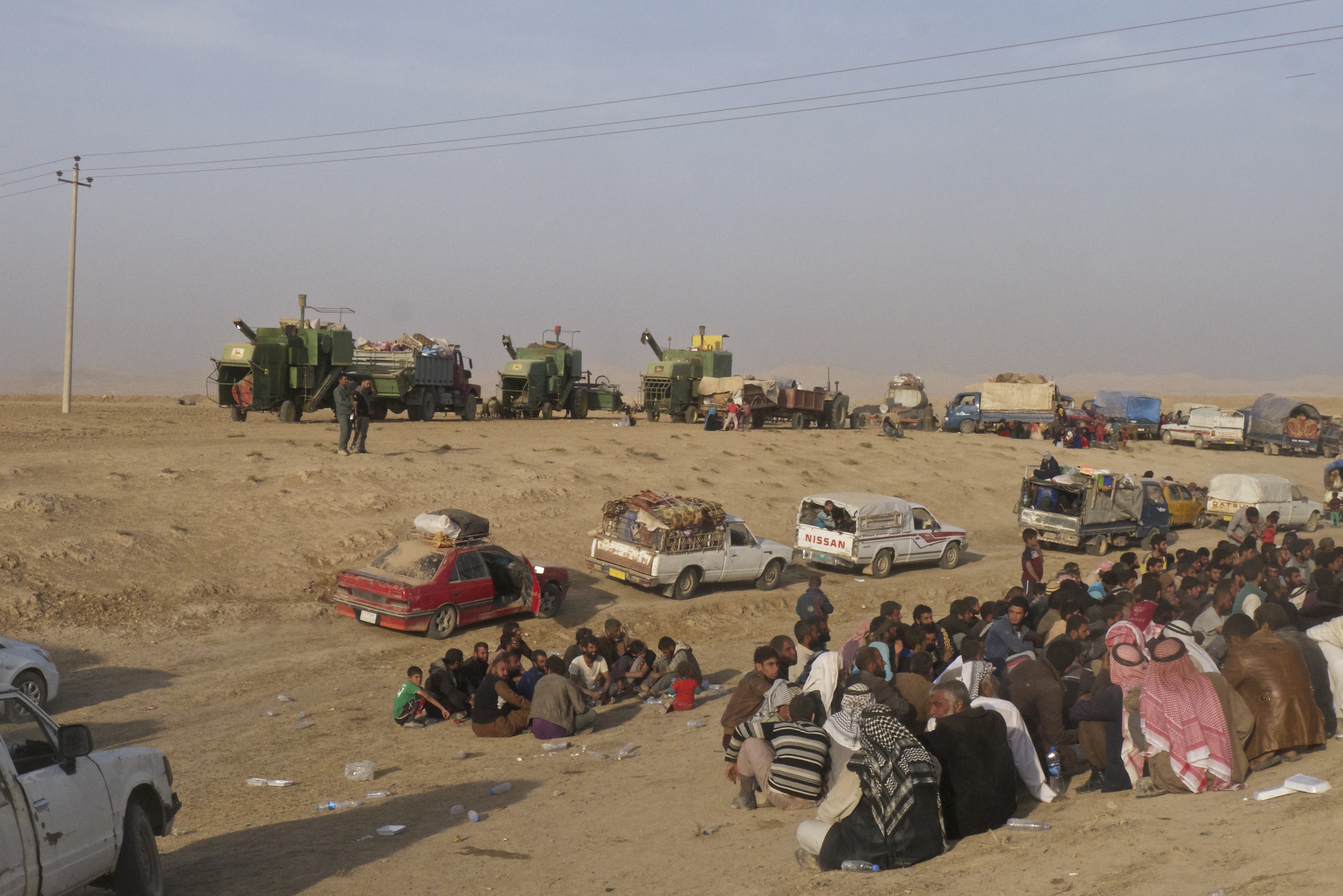 Men sit in the desert