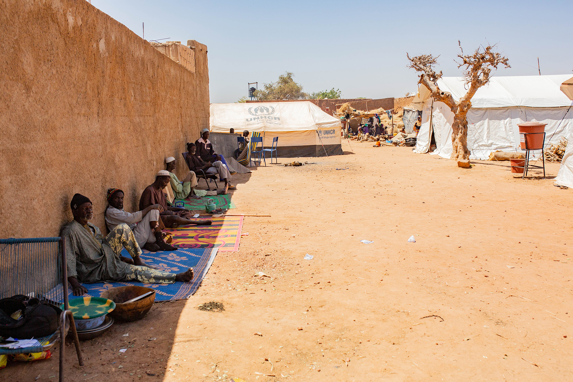 Men take shade from the sun at a displacement camp in central Mali’s Bandiagara region.