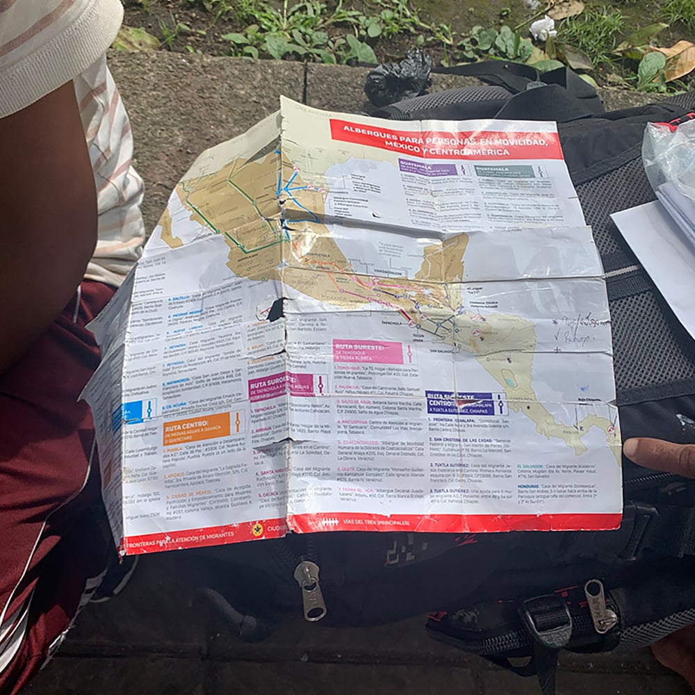 Migrants in Tapachula study a map provided by Mexican authorities of transit routes through the country.