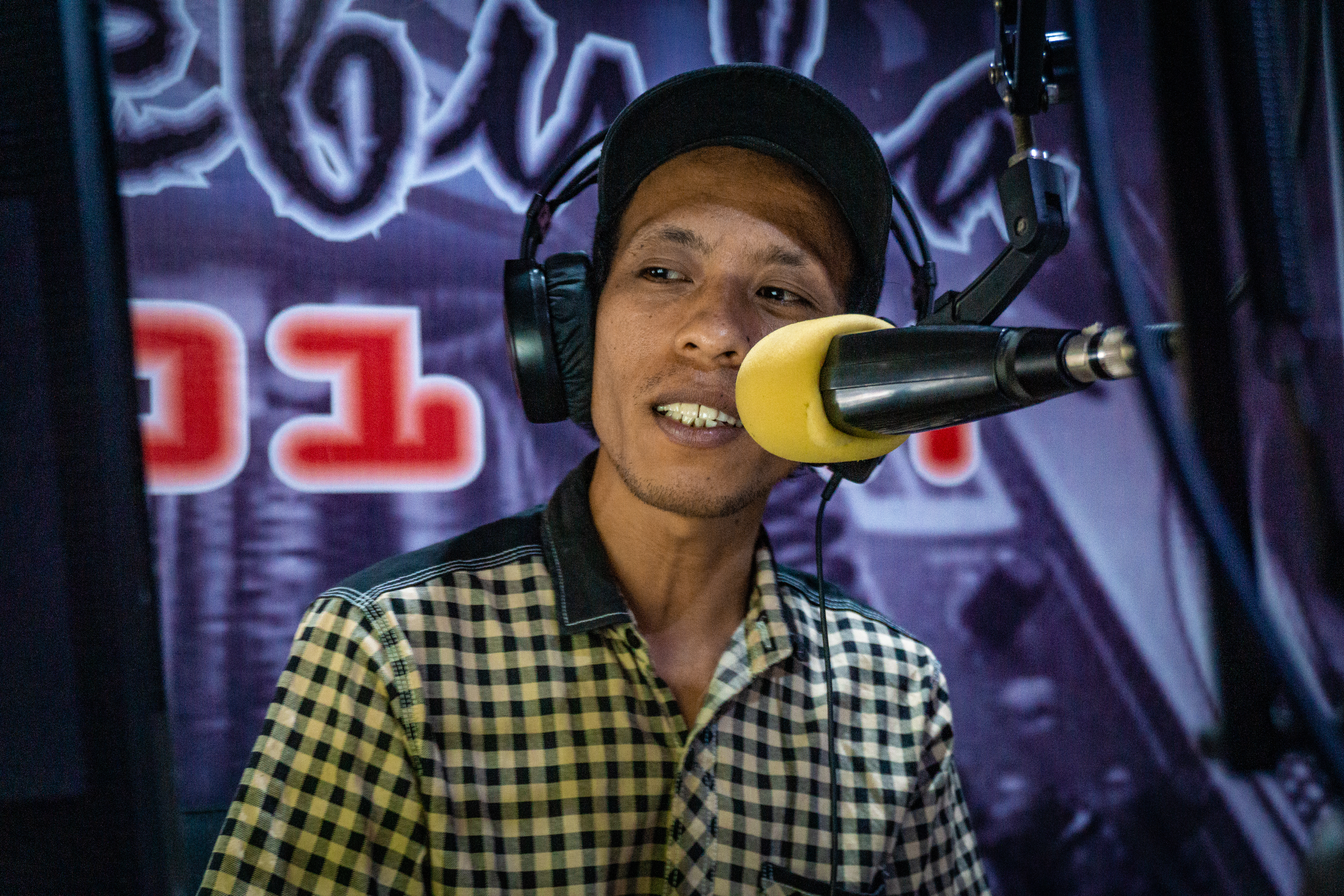 Delano Indonesian journalist on mic for Radio Nebula in Sulawesi