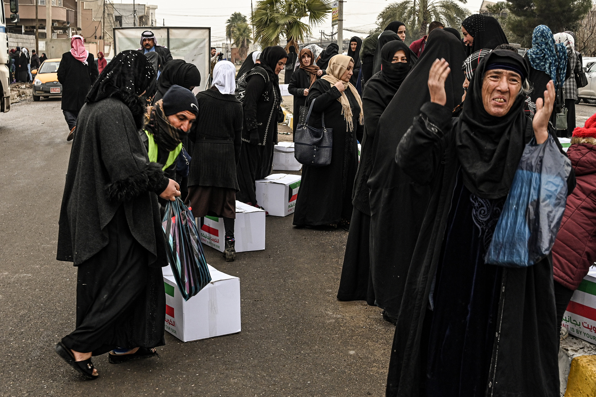 An image of women gathering at an aid distribution in east Mosul