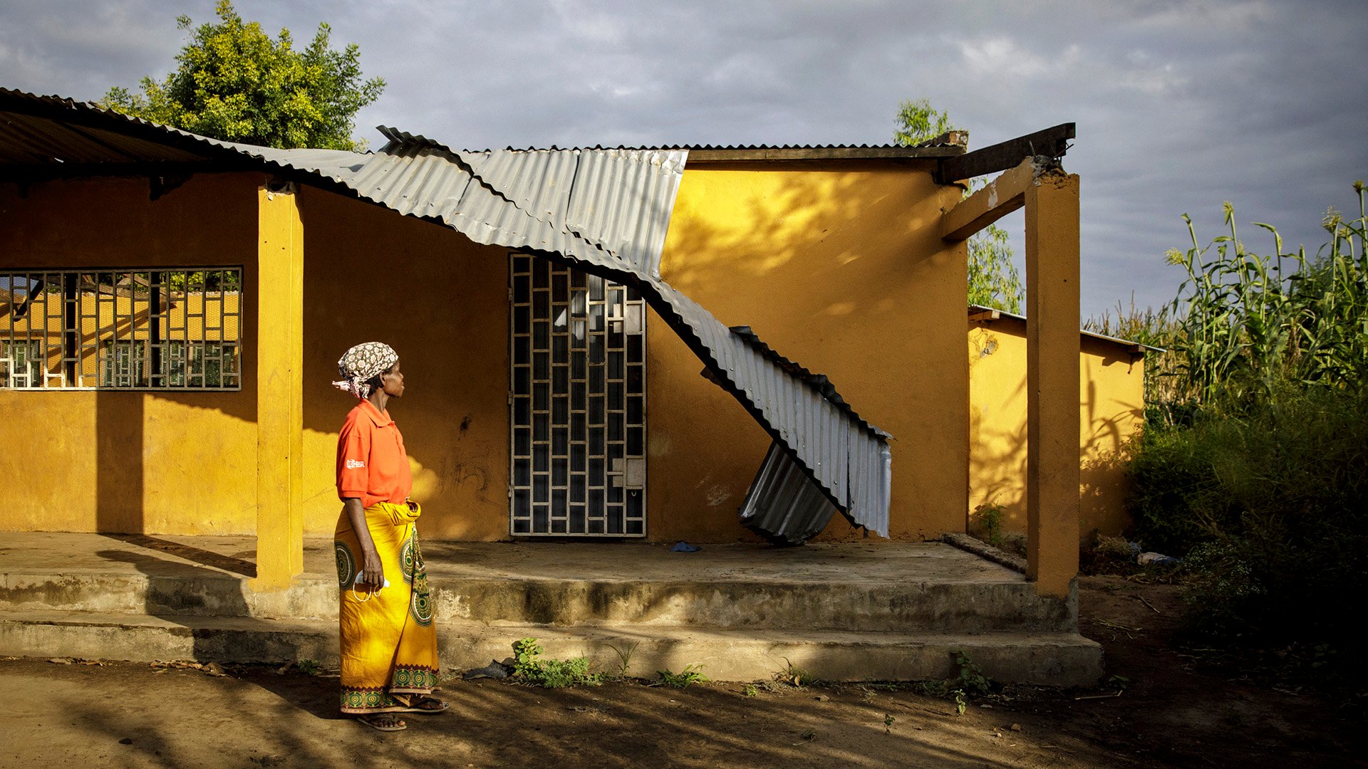 A woman looks up at a building destroyed by Cyclone Idai in 2019 in Nhamatanda, a town in Mozambique’s central Sofala province.