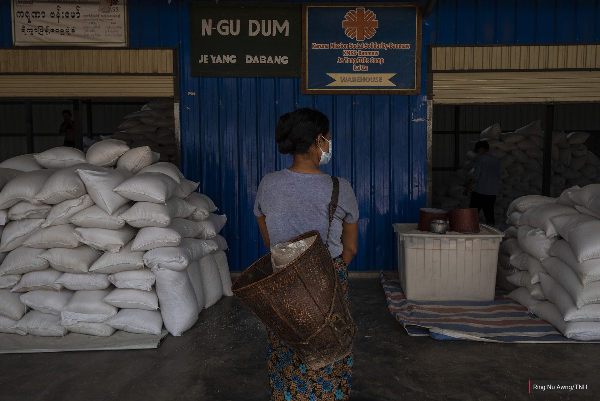 A woman in Je Yang IDP camp collects her family’s rations