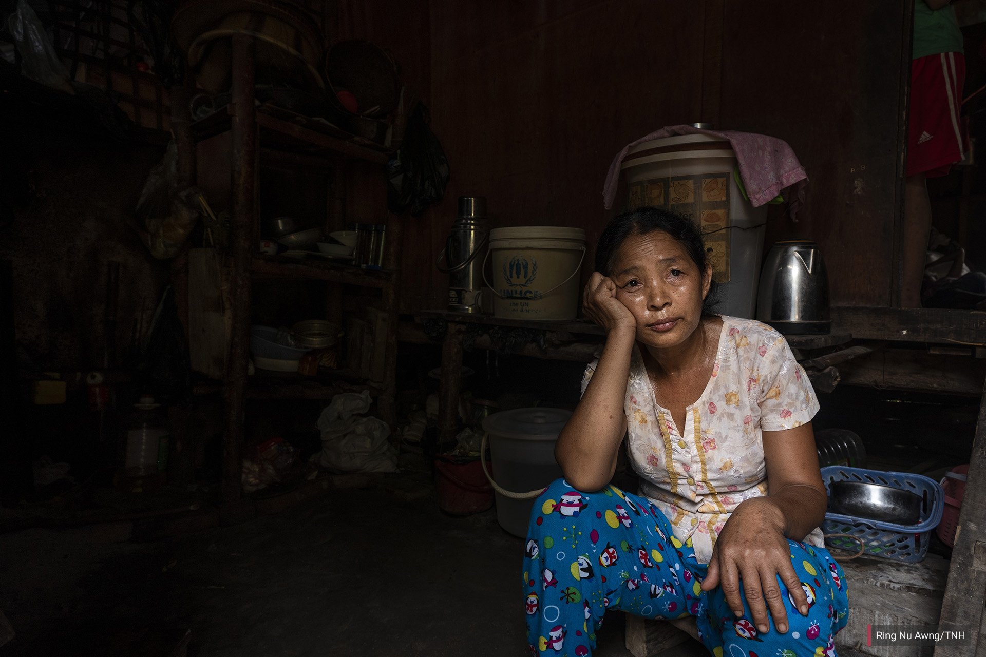 Lashi Lu, 48, sits in her shelter in Je Yang