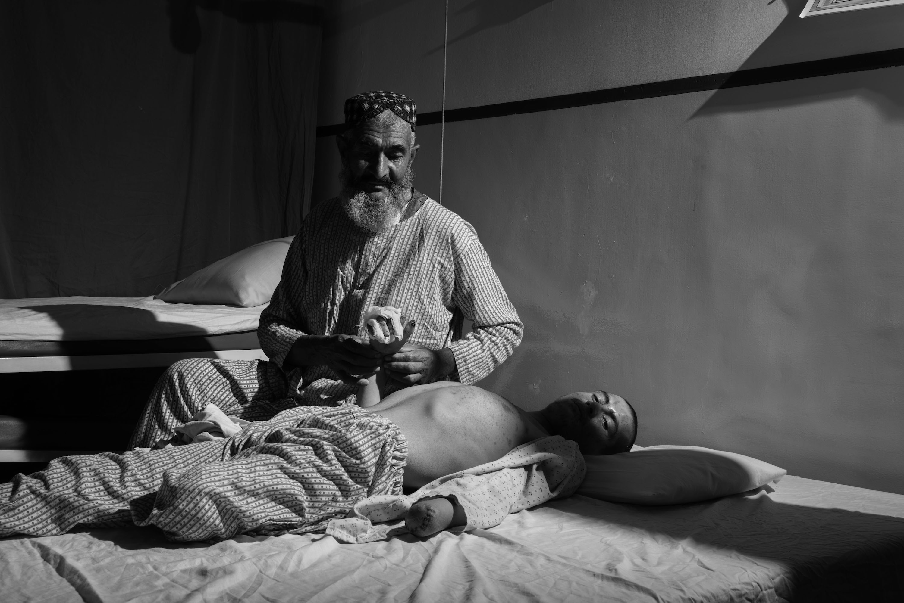 A father at his son's hospital bare hospital bed