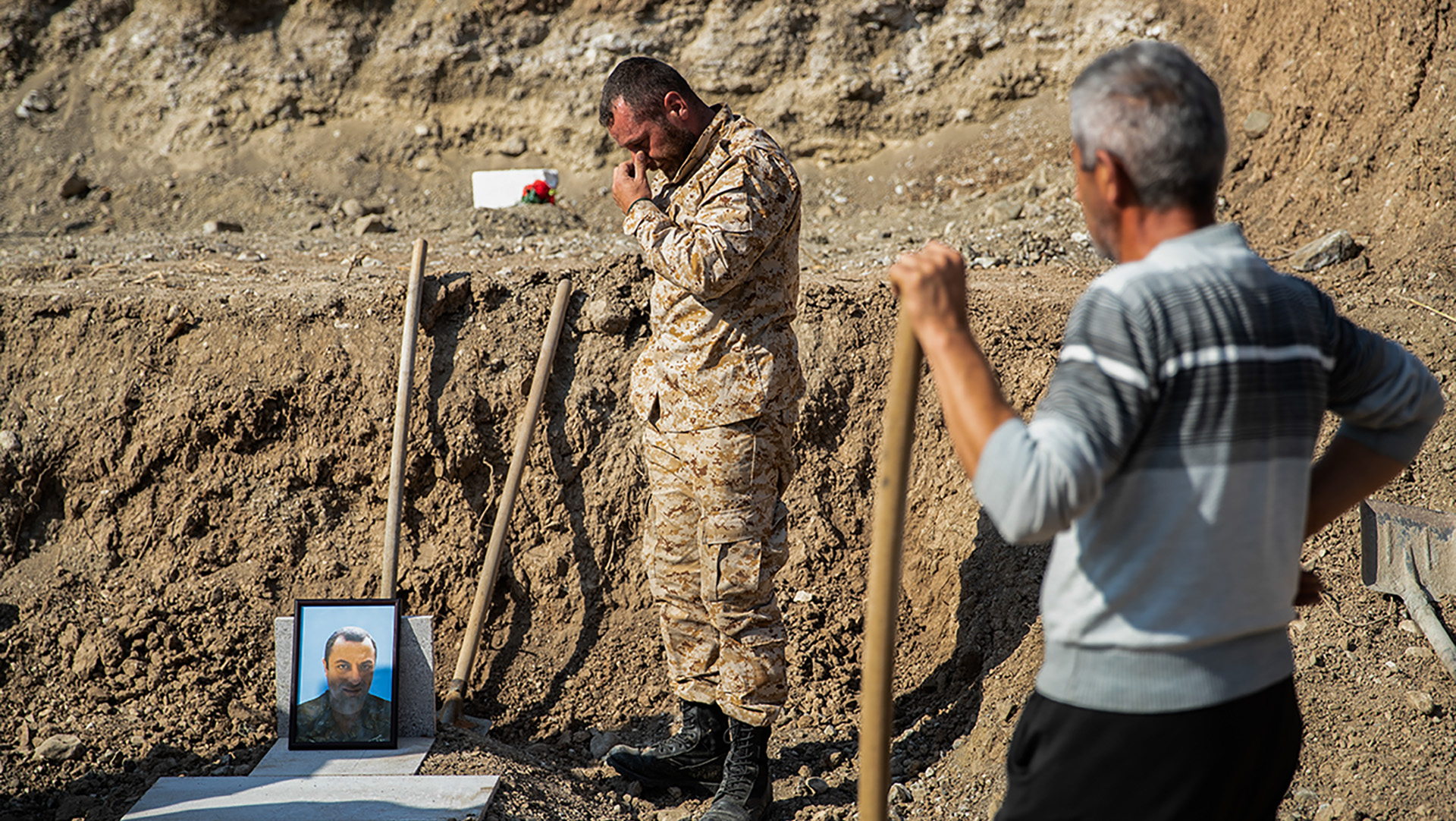 Local residents grieve during a funeral of a serviceman.