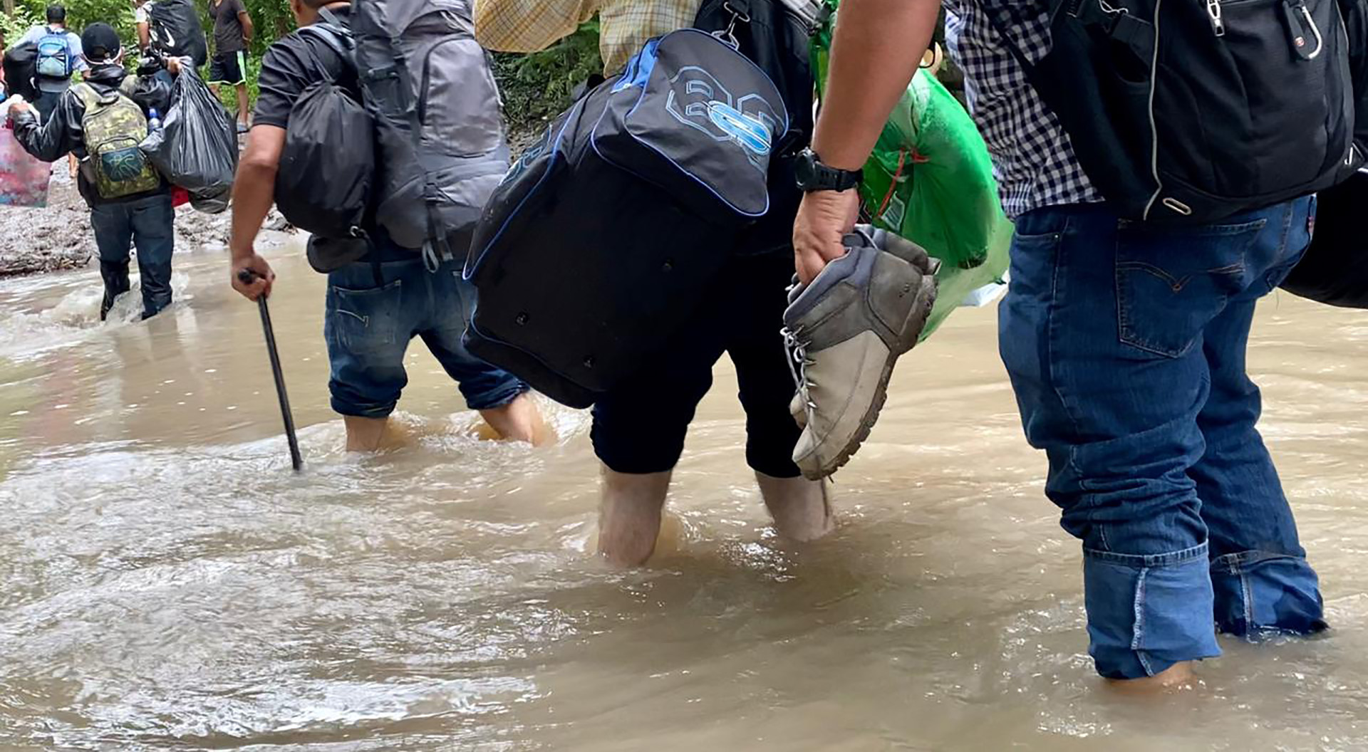 Nicaraguan migrants cross a river