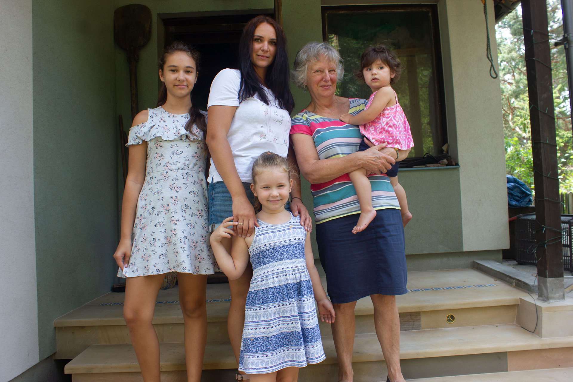 Oksana Zameynskaya, 38, with her nieces and one year old daughter, who is being held by their Polish host, Maria Borkowska, 67, on 27 June.