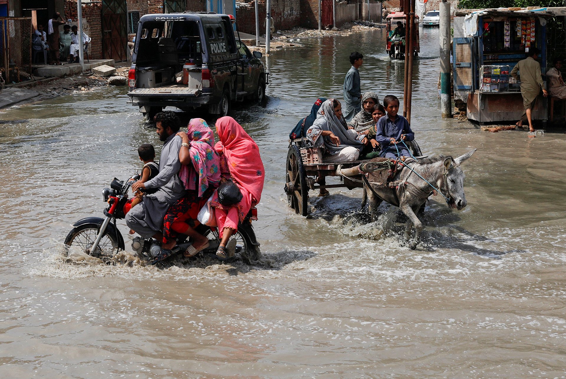 Commuters travel through floodwaters in Jacobabad on 30 August 2022.