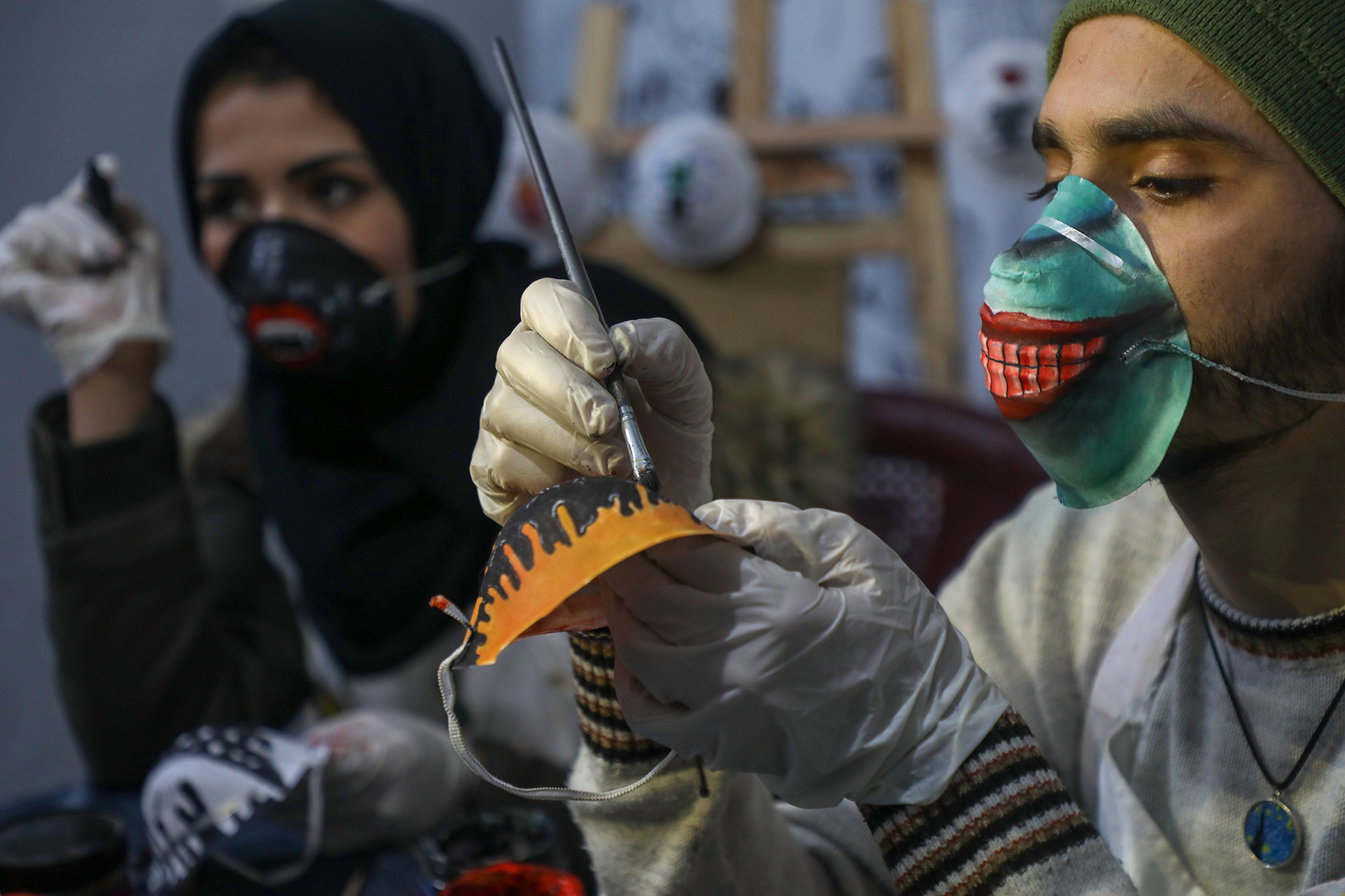 Artists in Gaza paint on face masks