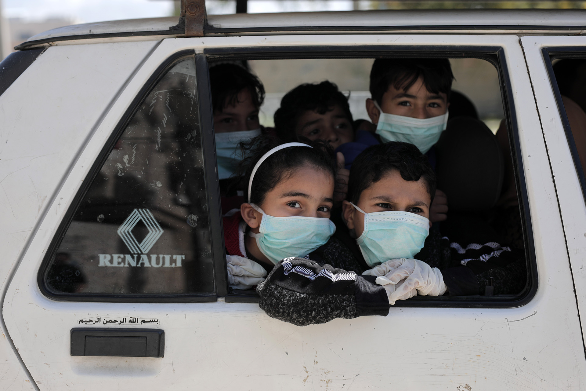 Children wear surgical masks in Gaza