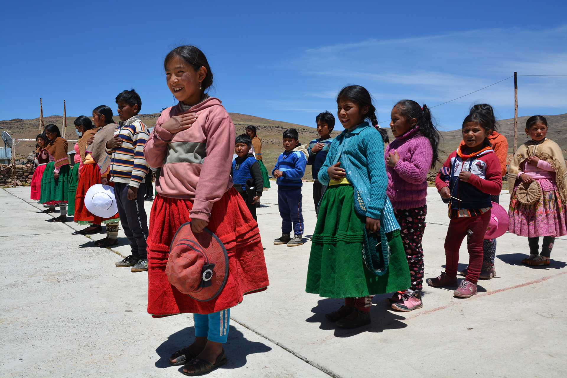 Children in Tarucani singing the national anthem to visiting officials in October. Classes have restarted, but only twice a week with all years in together.