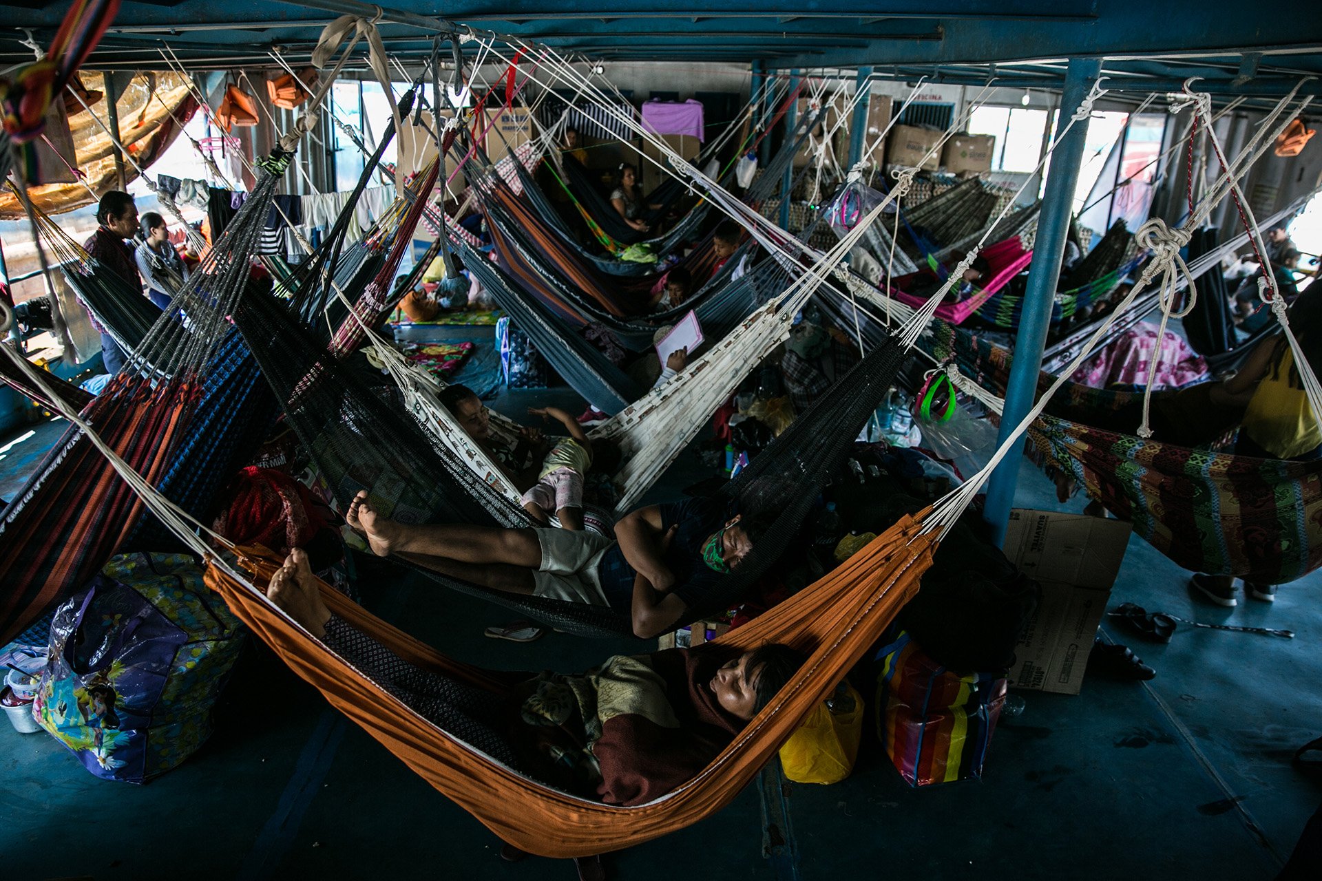 Image of residents from Amazon River communities waiting in tight quarters in Pucallpa