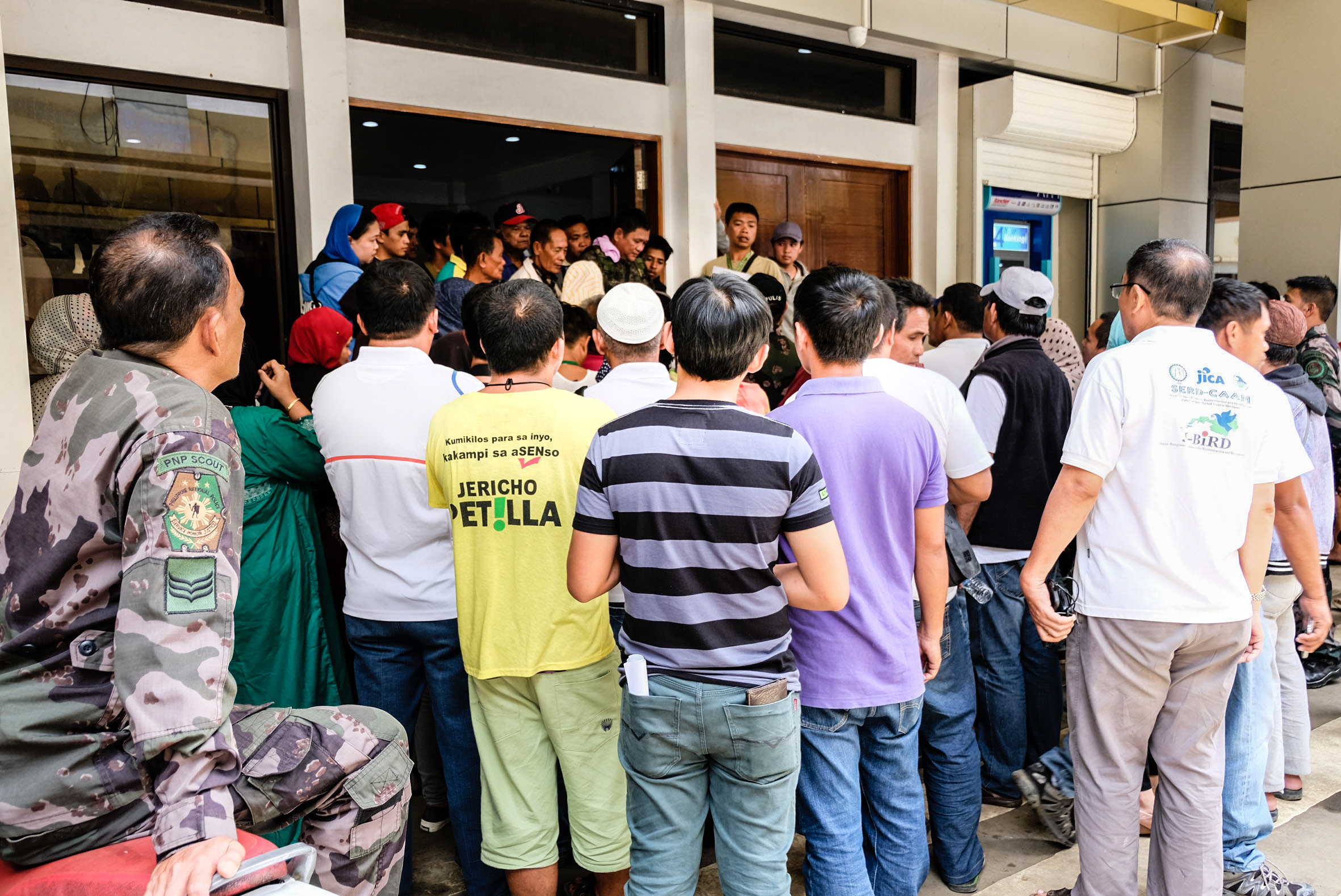 Residents of Marawi, Philippines wait outside a government building.