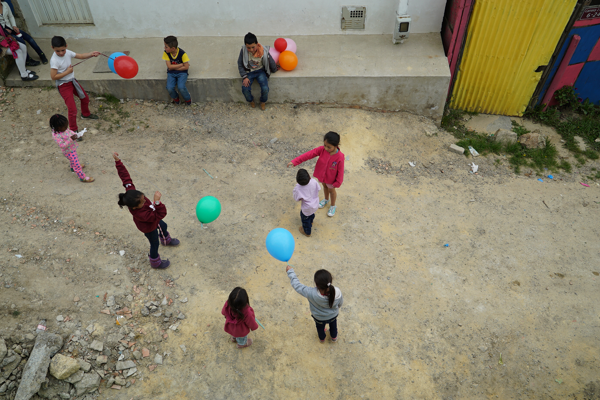 Photo of children playing on an unpaved road in Soacha Alta, Colombia