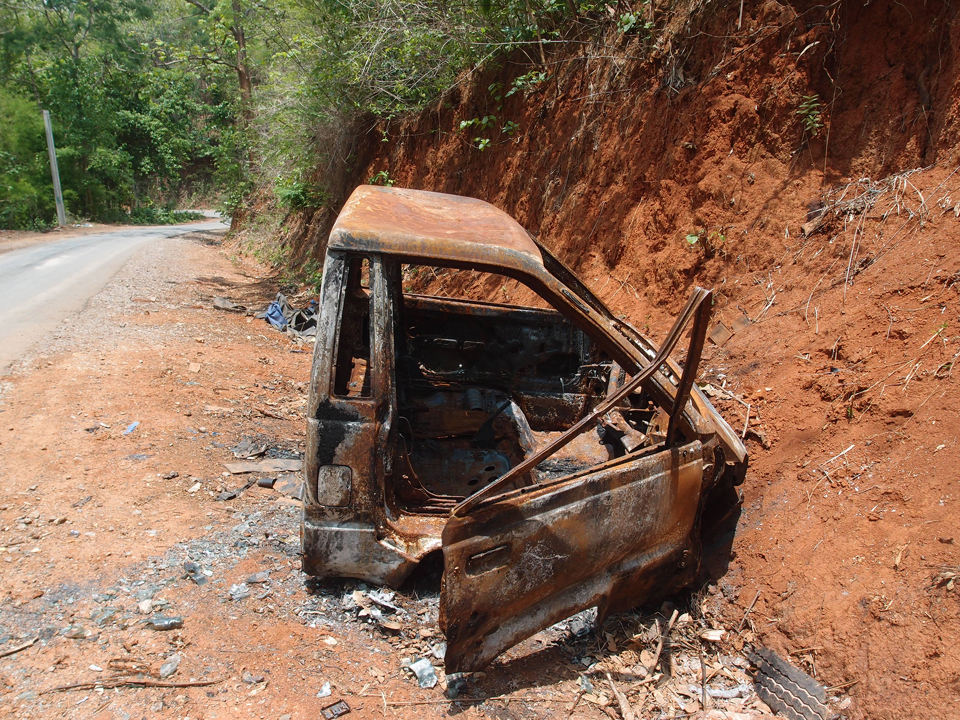 Photo of an exploded vehicle on the side of a road