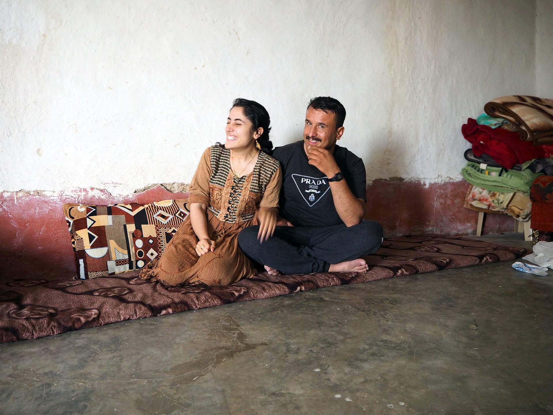 Photo of a husband and wife smiling and laughing near Sinjar, Iraq