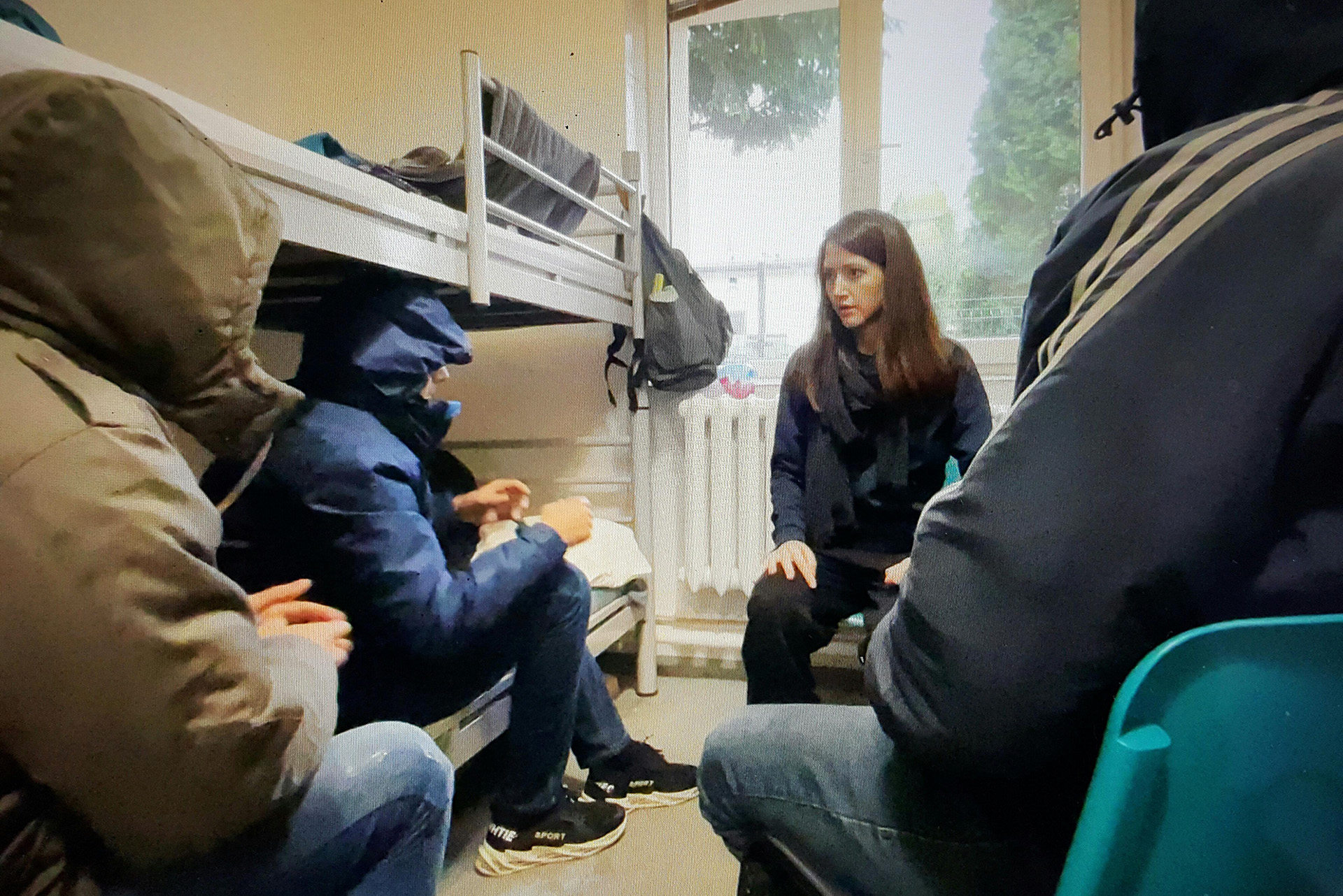 Fadi, Elias, and their friend speak with the author at a migrant shelter in the border region.