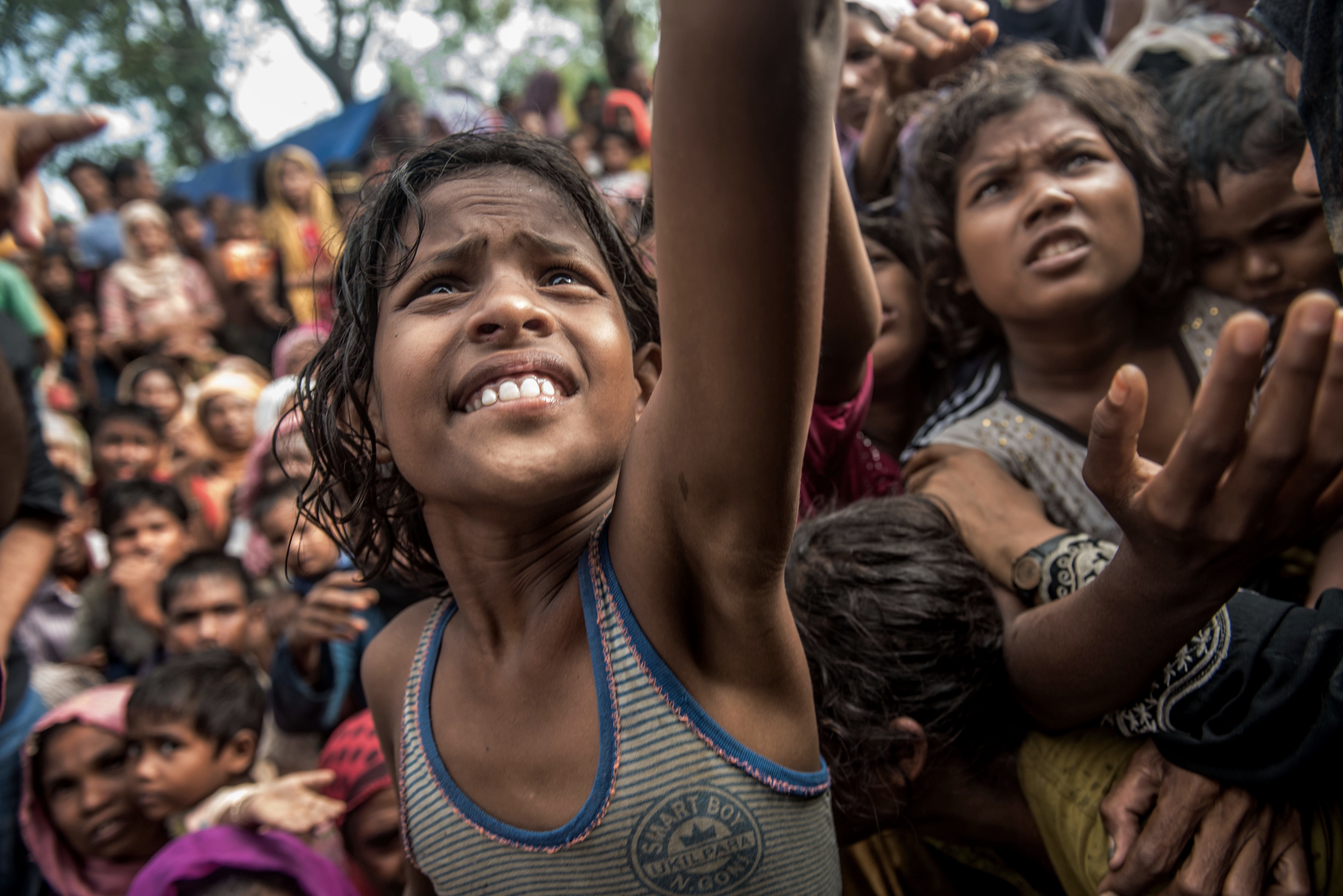 Children reach for food handouts