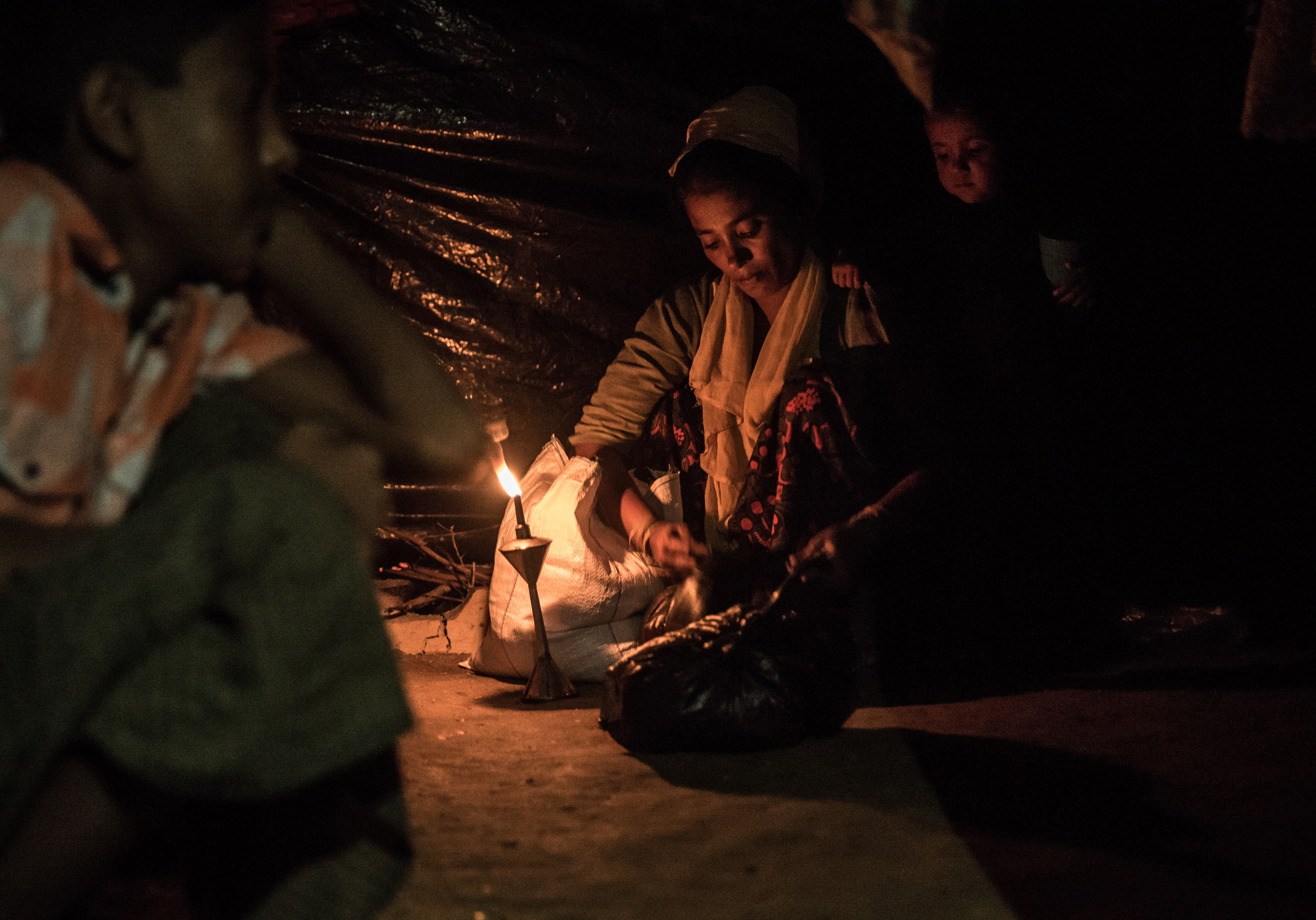 Woman lights a fire