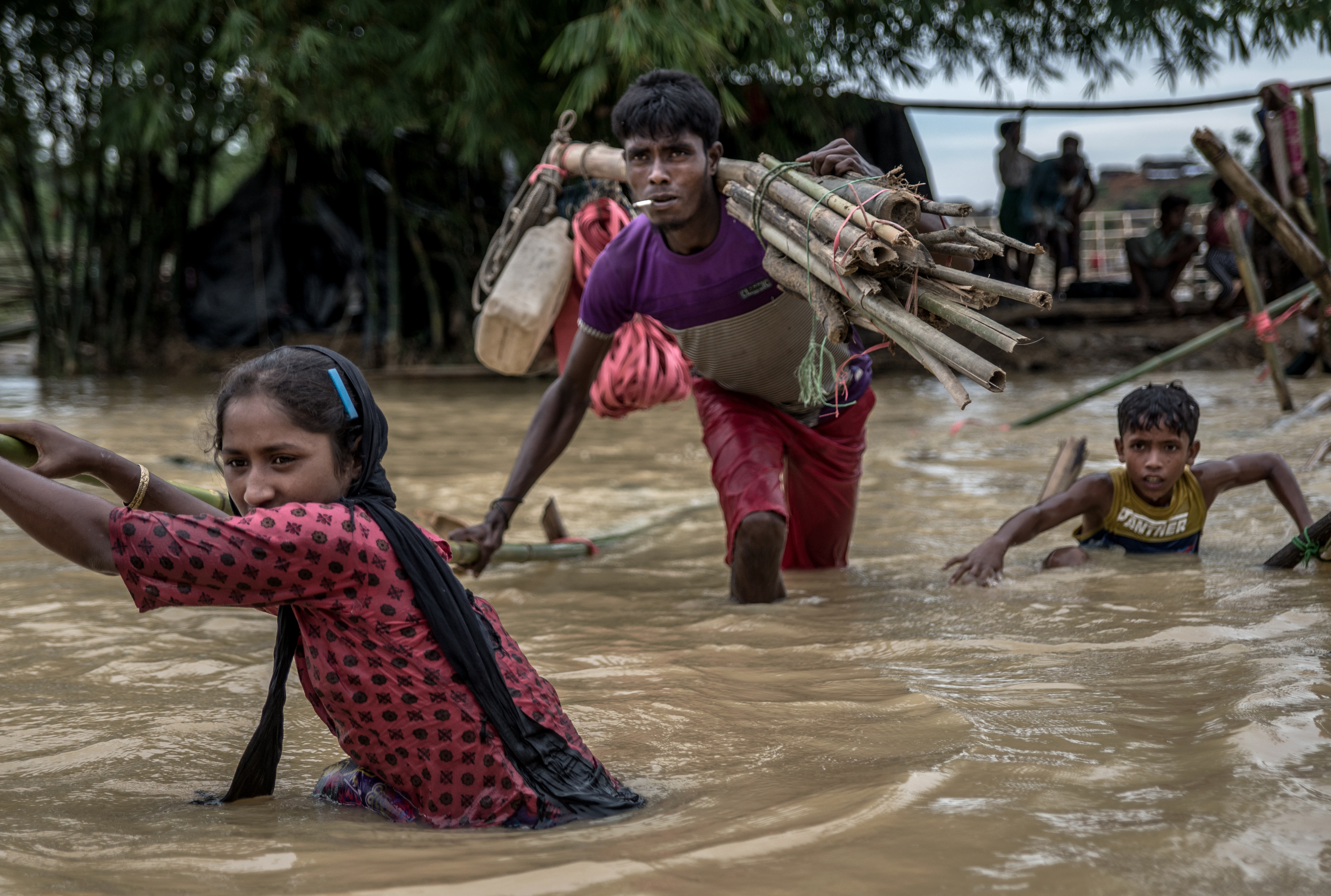 People walk across river