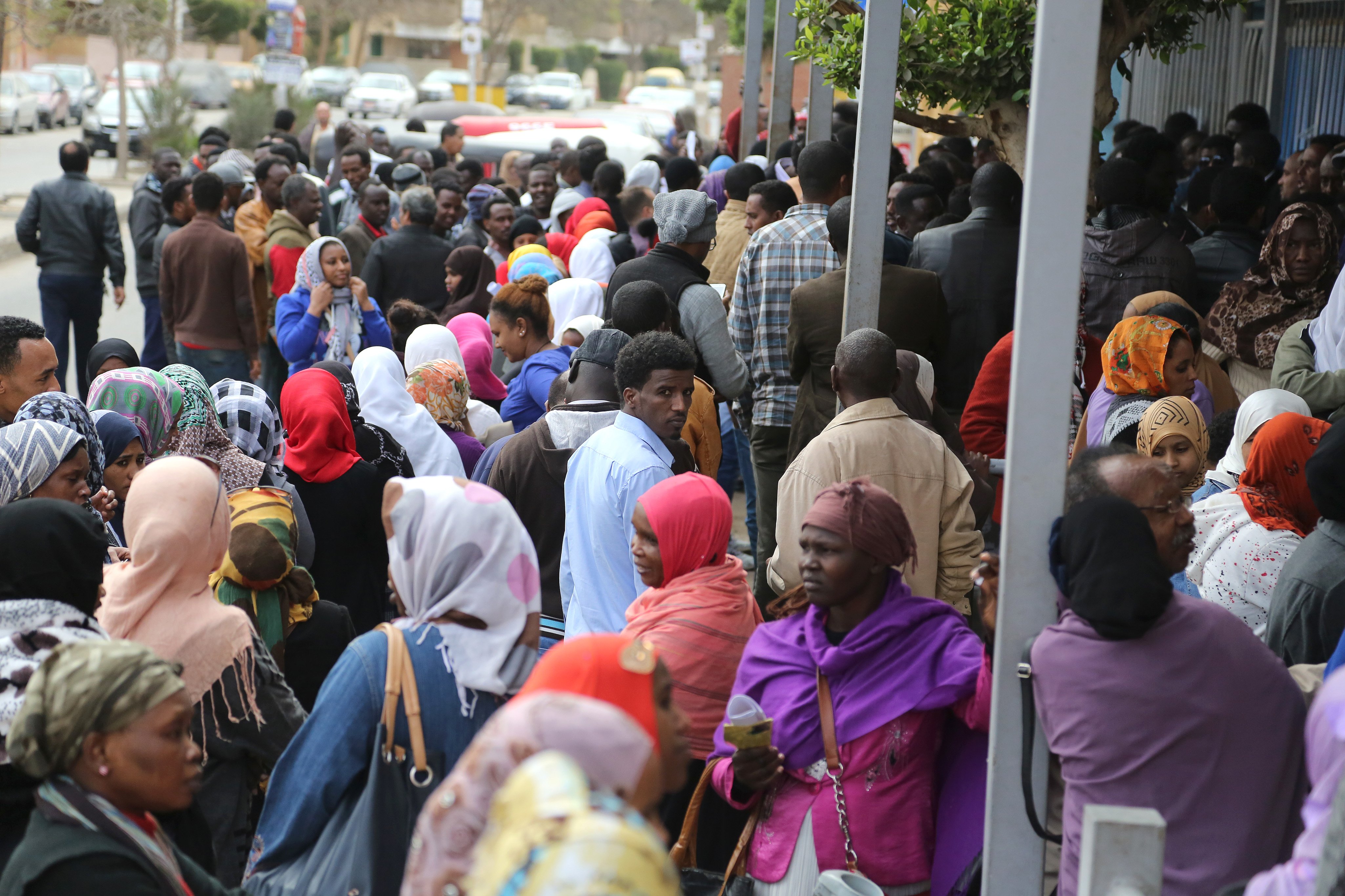 Refugees queue to be registered as they wait outside UNHCR office in 6th of October city at the outskirts of Cairo, Egypt