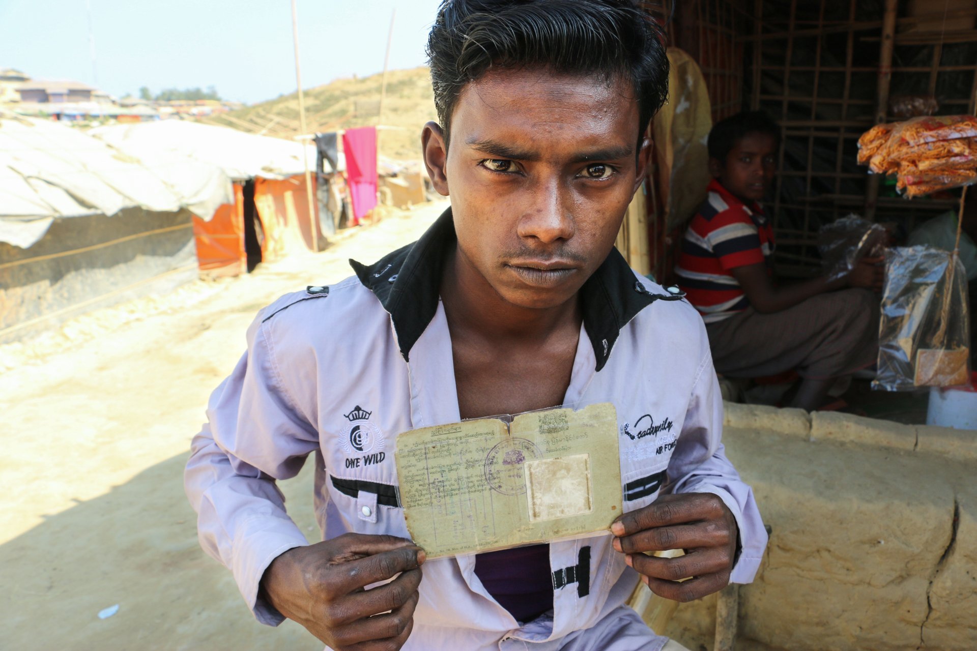 Nurul Hoque sealed his family’s ID cards and old photos in plastic after arriving in Bangladesh. He keeps them under his pillow when he sleeps.